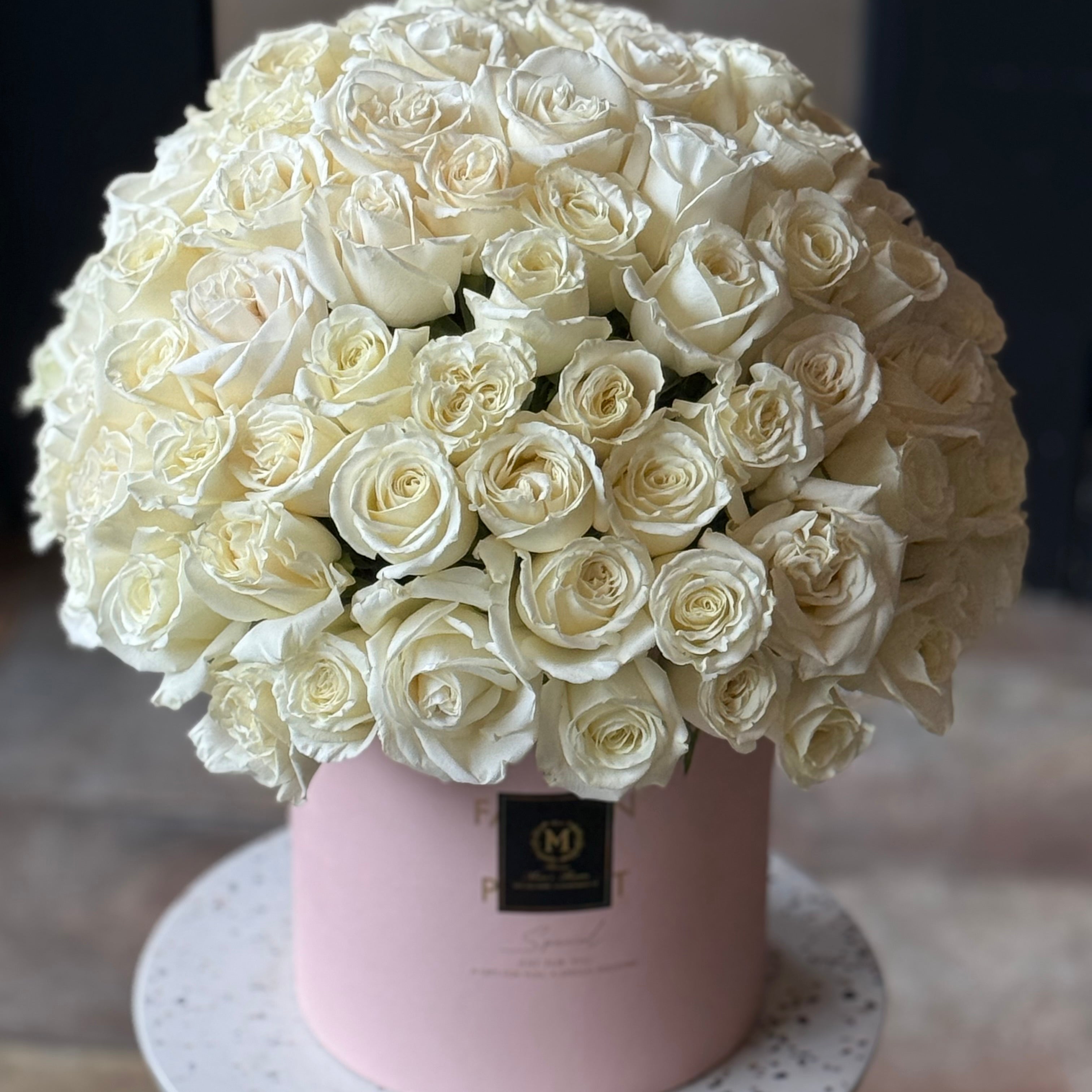 50 white roses arranged in a premium rose box