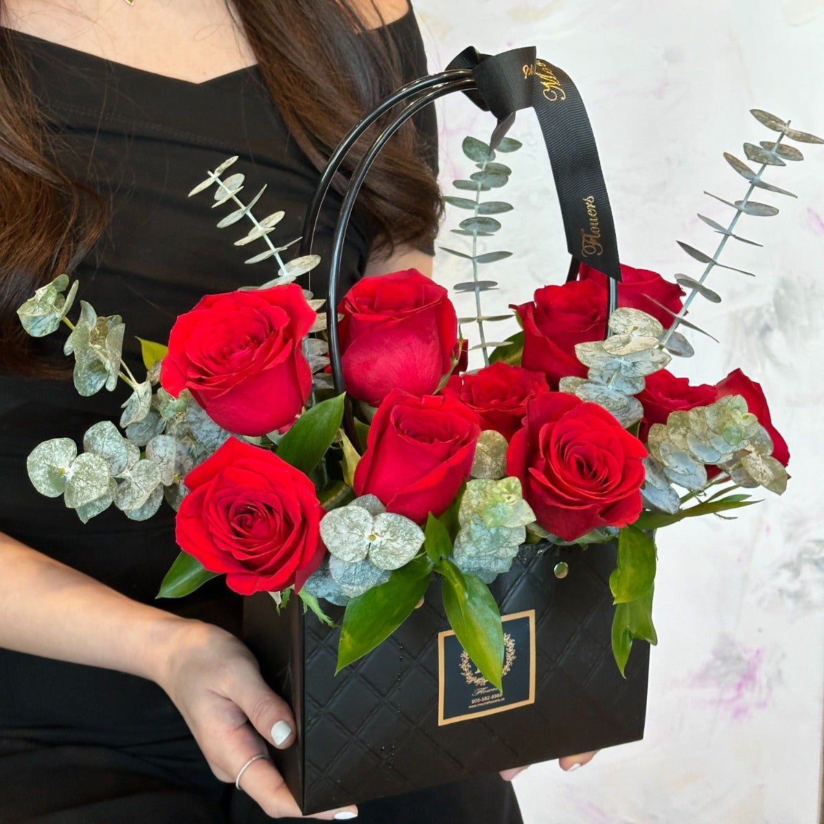 Dozen red roses in a basket