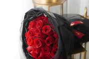 Red roses laid flat showcasing the rich color and fullness of the blooms