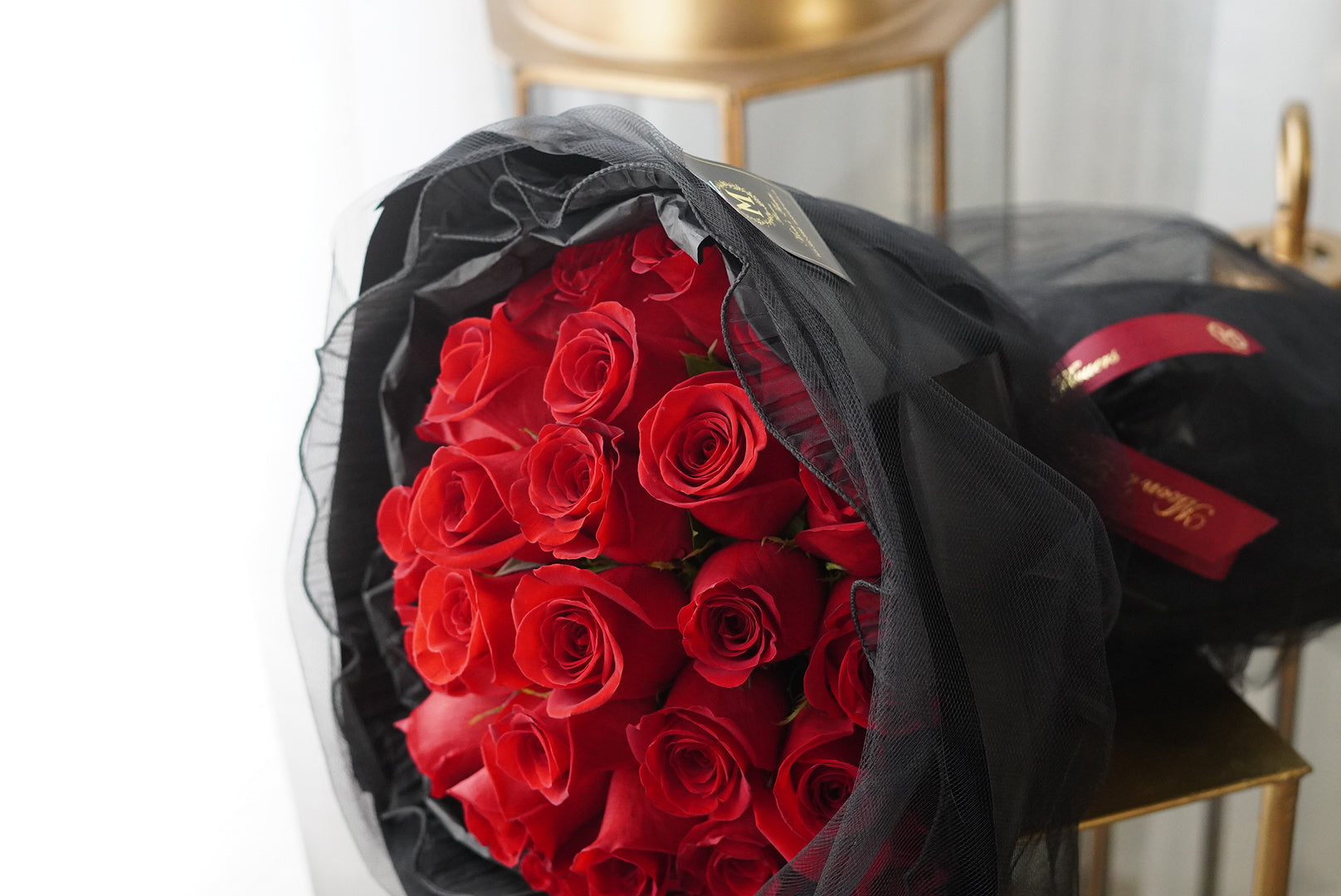 Red roses laid flat showcasing the rich color and fullness of the blooms