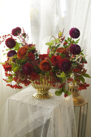 Luxury autumn floral centerpiece with roses, burgundy blooms, and seasonal foliage