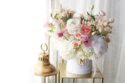 Elegant pastel flower box with pink and white blooms arranged in luxury hat box