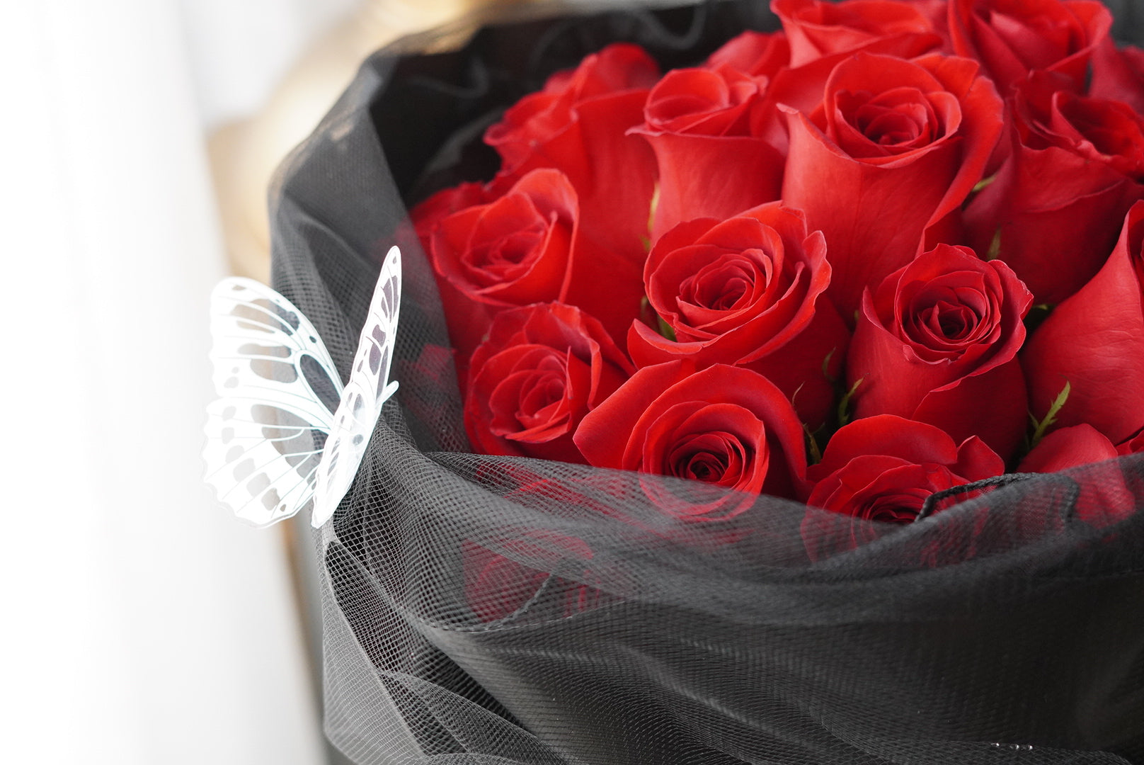 Close-up of red roses tightly arranged in a full round bouquet