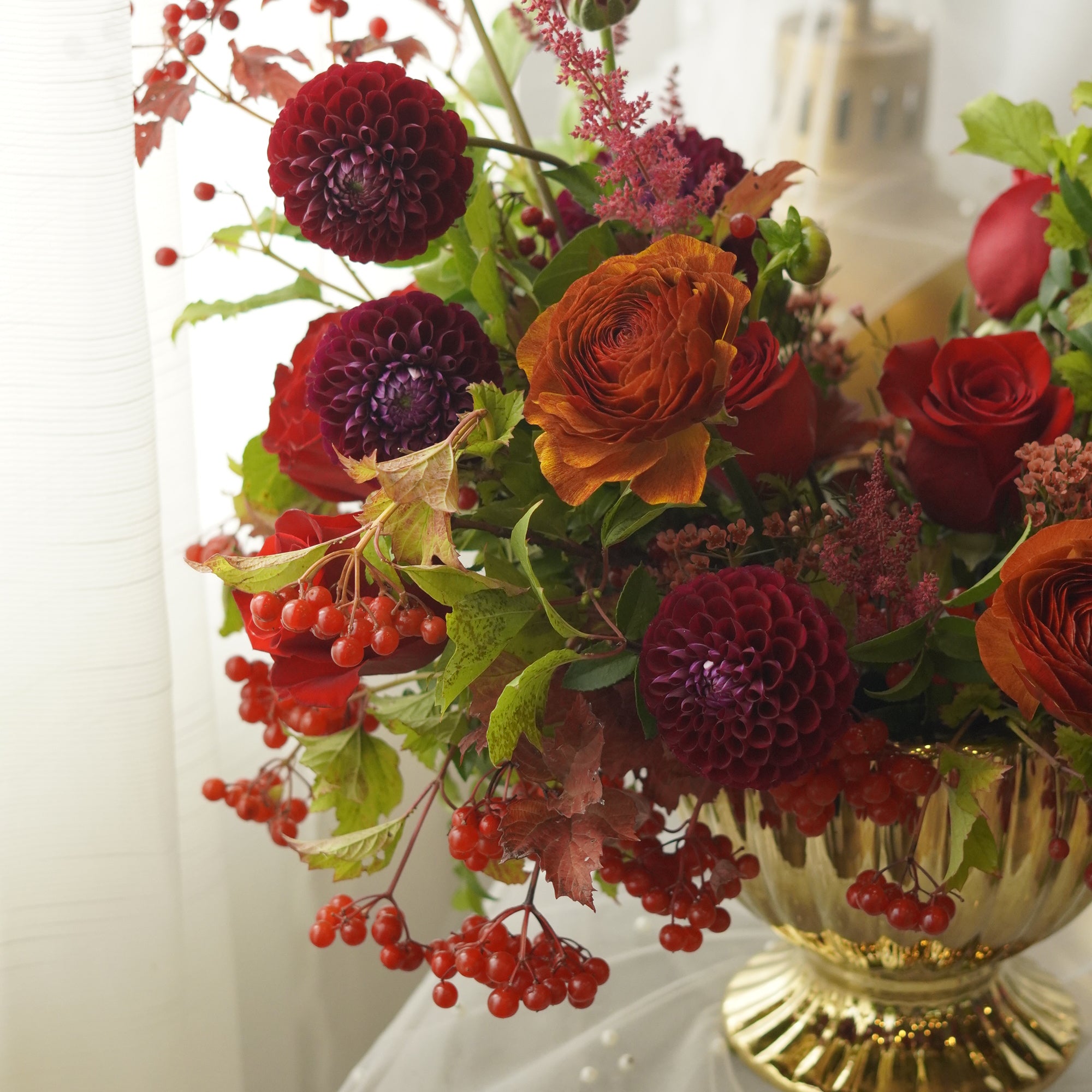 Burgundy dahlia-style blooms, red roses, and autumn berries — Oakville florist