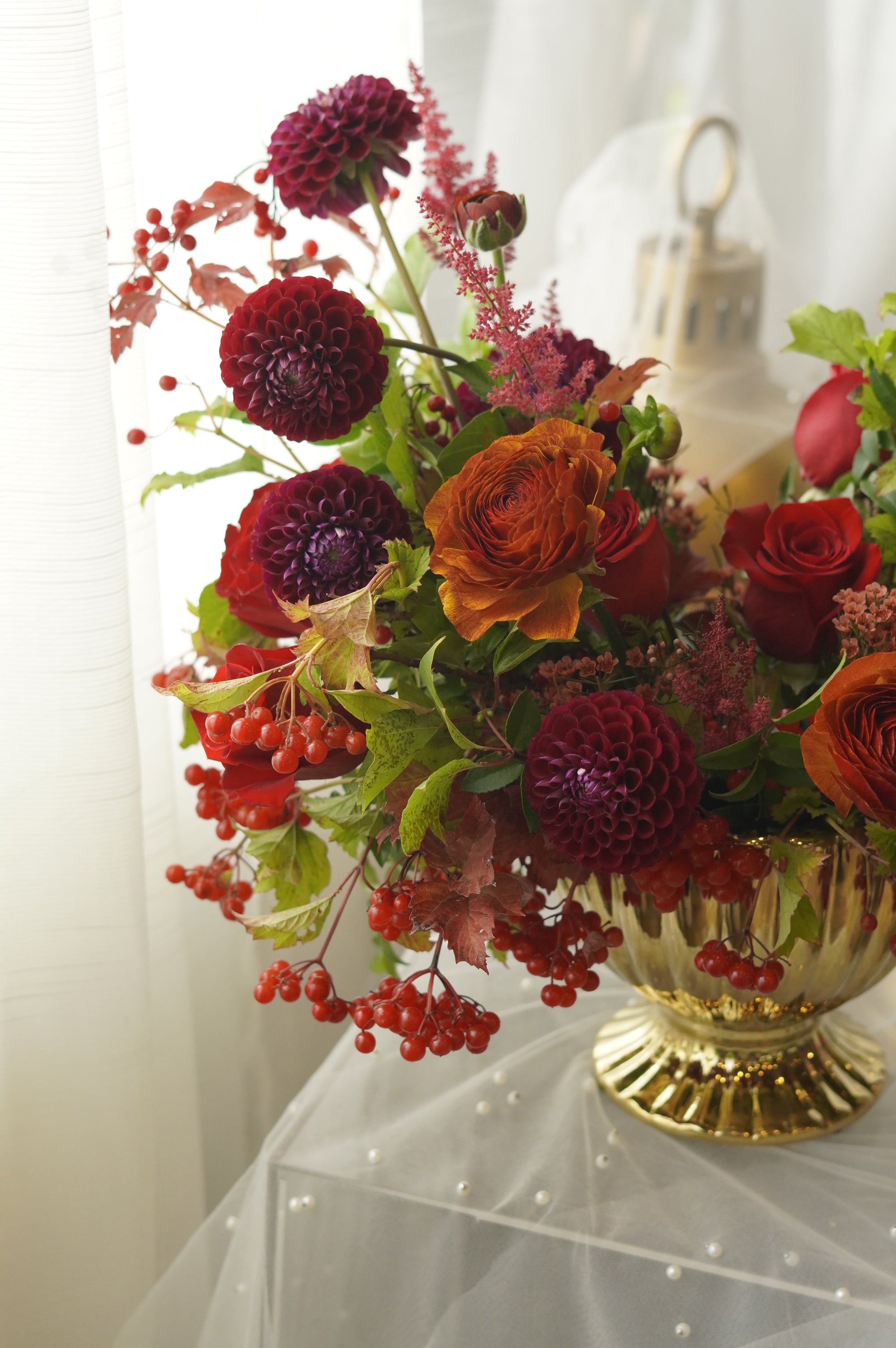 Burgundy dahlia-style blooms, red roses, and autumn berries — Oakville florist