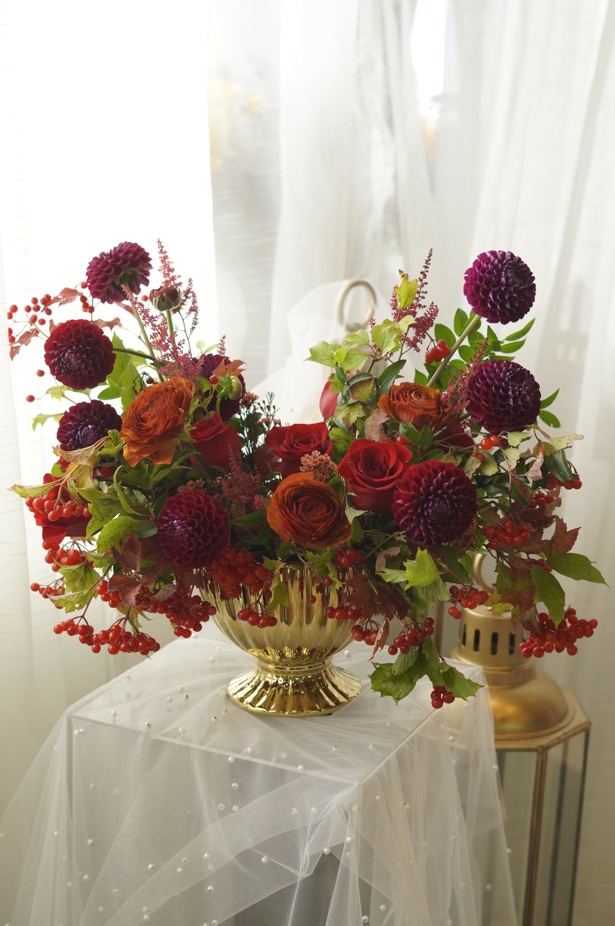 Full autumn flower arrangement in a sculptural gold urn — GTA flower delivery