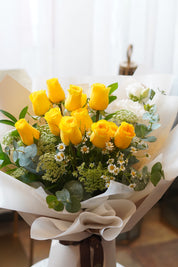 Close-up of premium yellow roses with white daisies and greenery – order flowers online Toronto GTA
