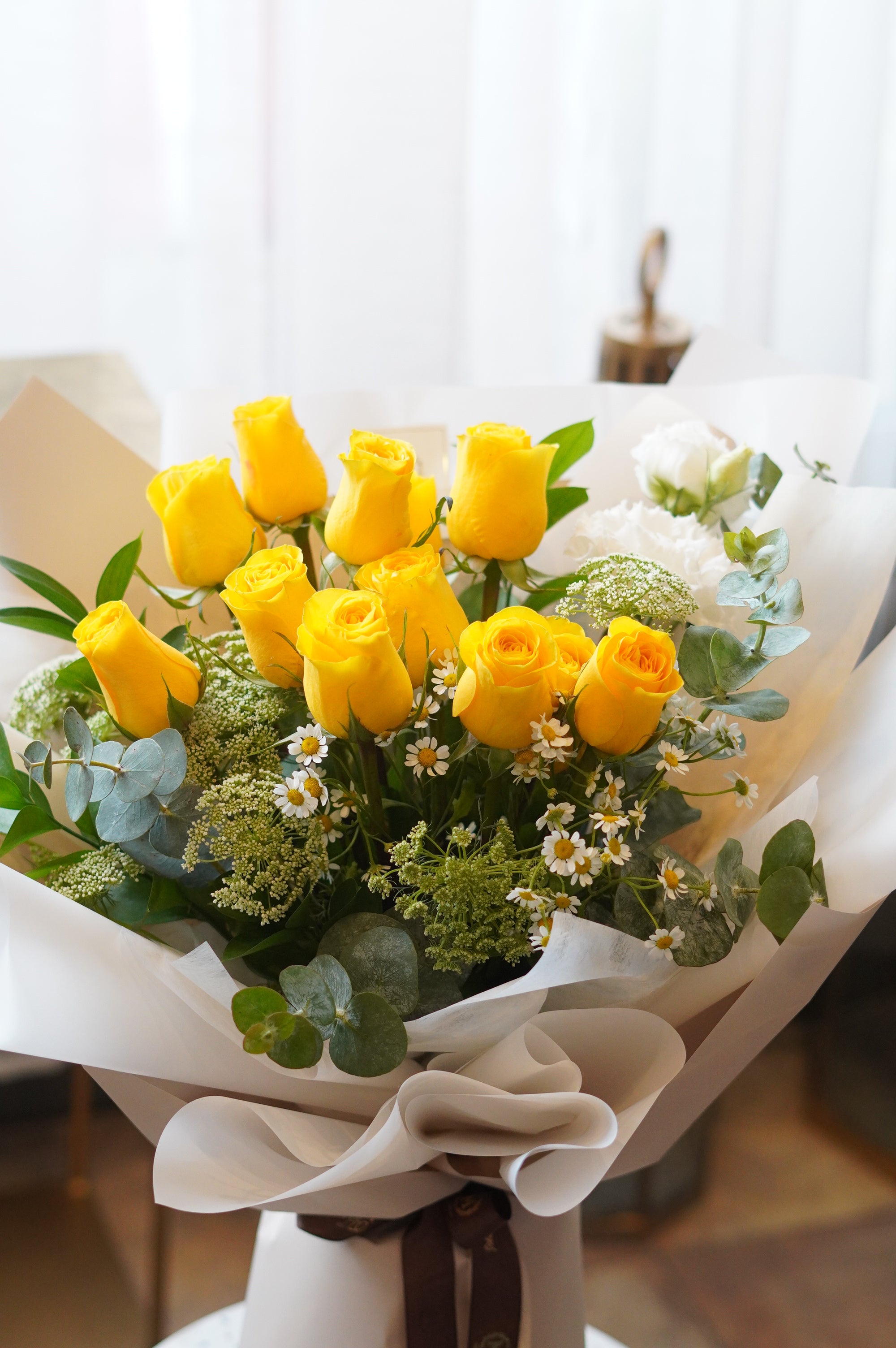 Close-up of premium yellow roses with white daisies and greenery – order flowers online Toronto GTA
