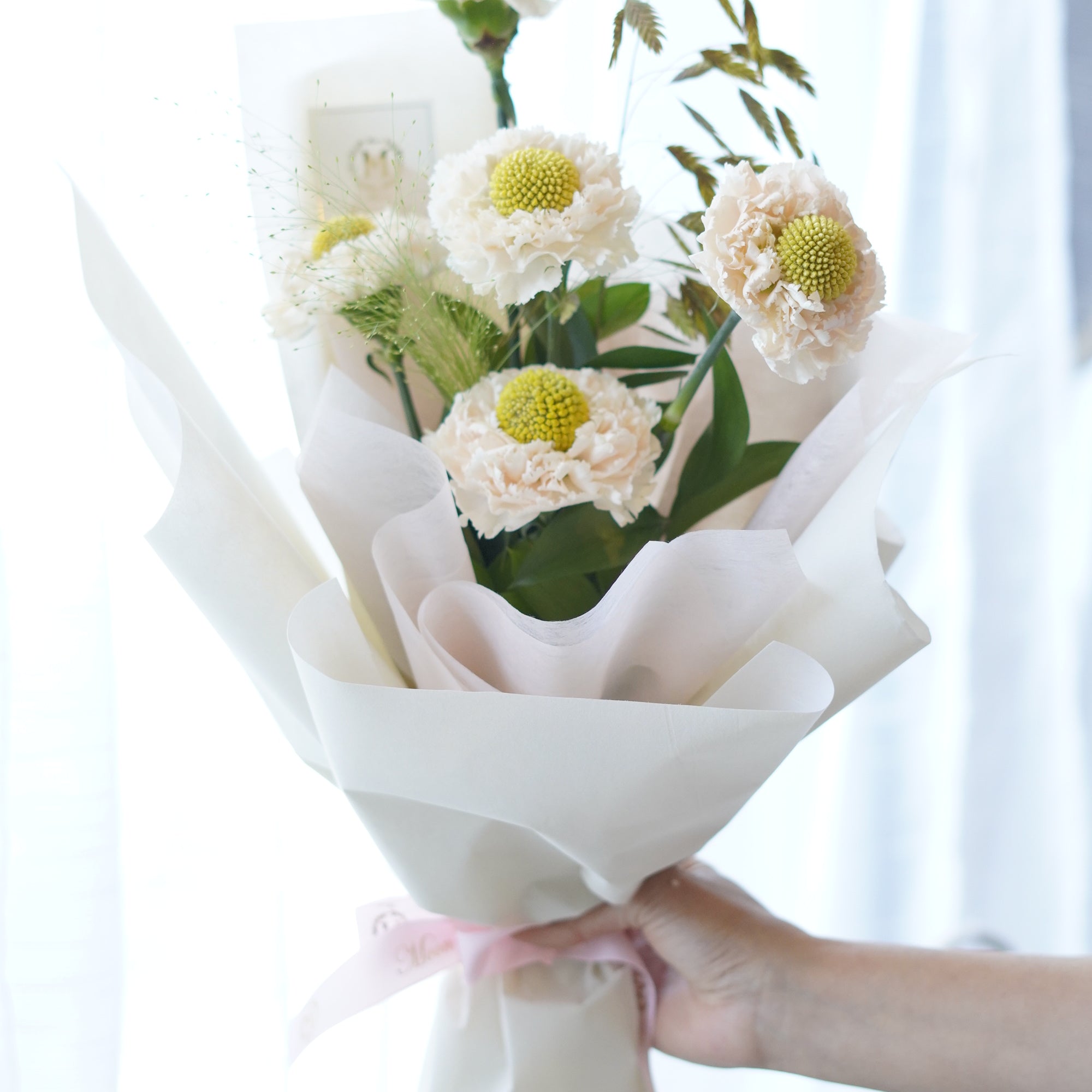 Ivory Dream Carnation Bouquet – blush white carnations with green button centres, wrapped in matte white paper, Toronto florist
