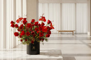 A stunning large modern red floral arrangement in a black gift box, perfect for a high end Mother's Day gift.