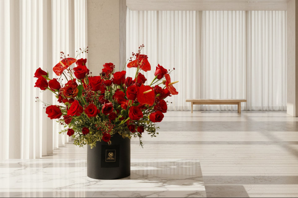 A stunning large modern red floral arrangement in a black gift box, perfect for a high end Mother's Day gift.