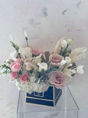 A vibrant pink rose and lily bouquet from Moon's Flowers. Handcrafted floral gift