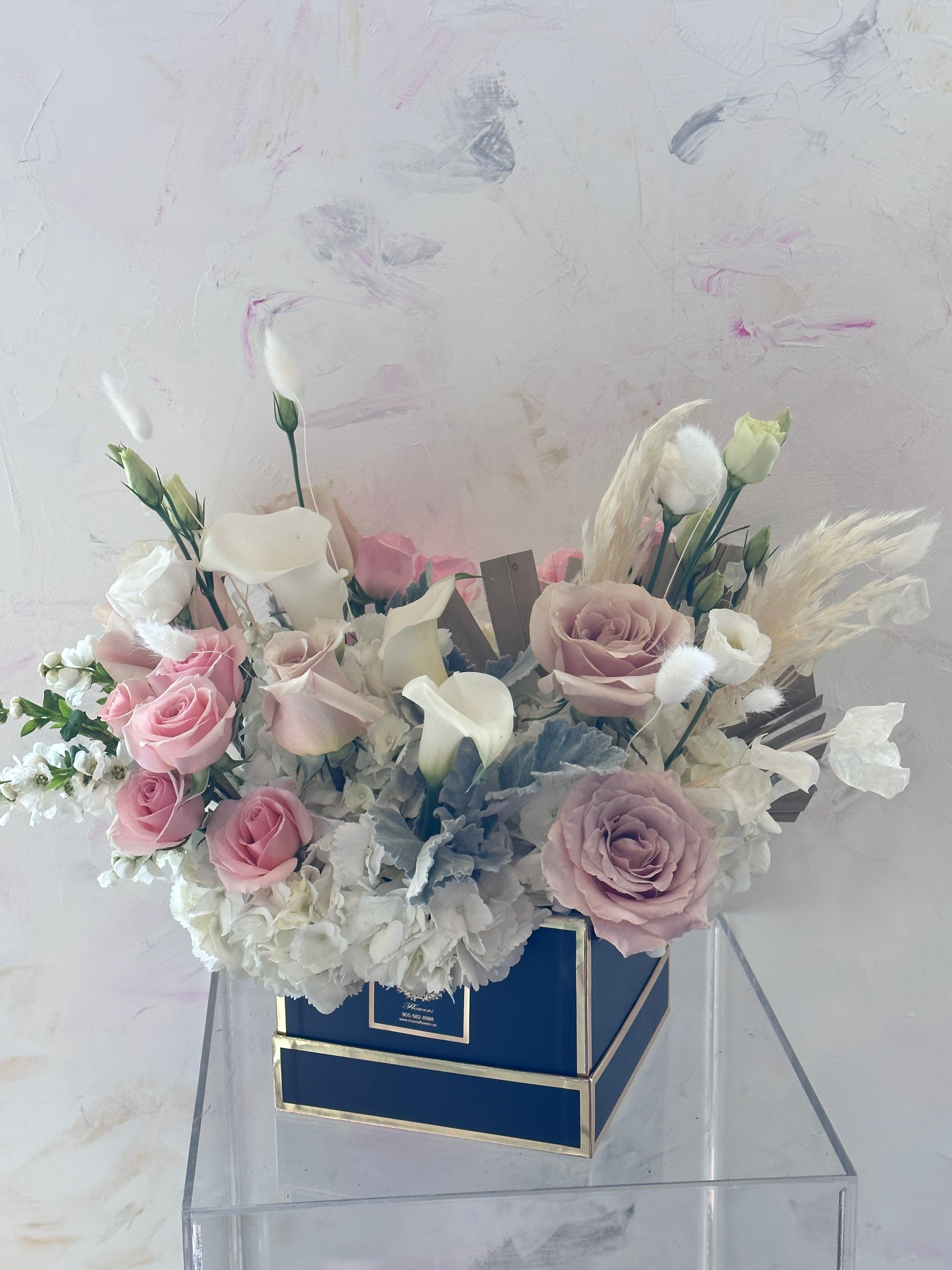 A vibrant pink rose and lily bouquet from Moon's Flowers. Handcrafted floral gift