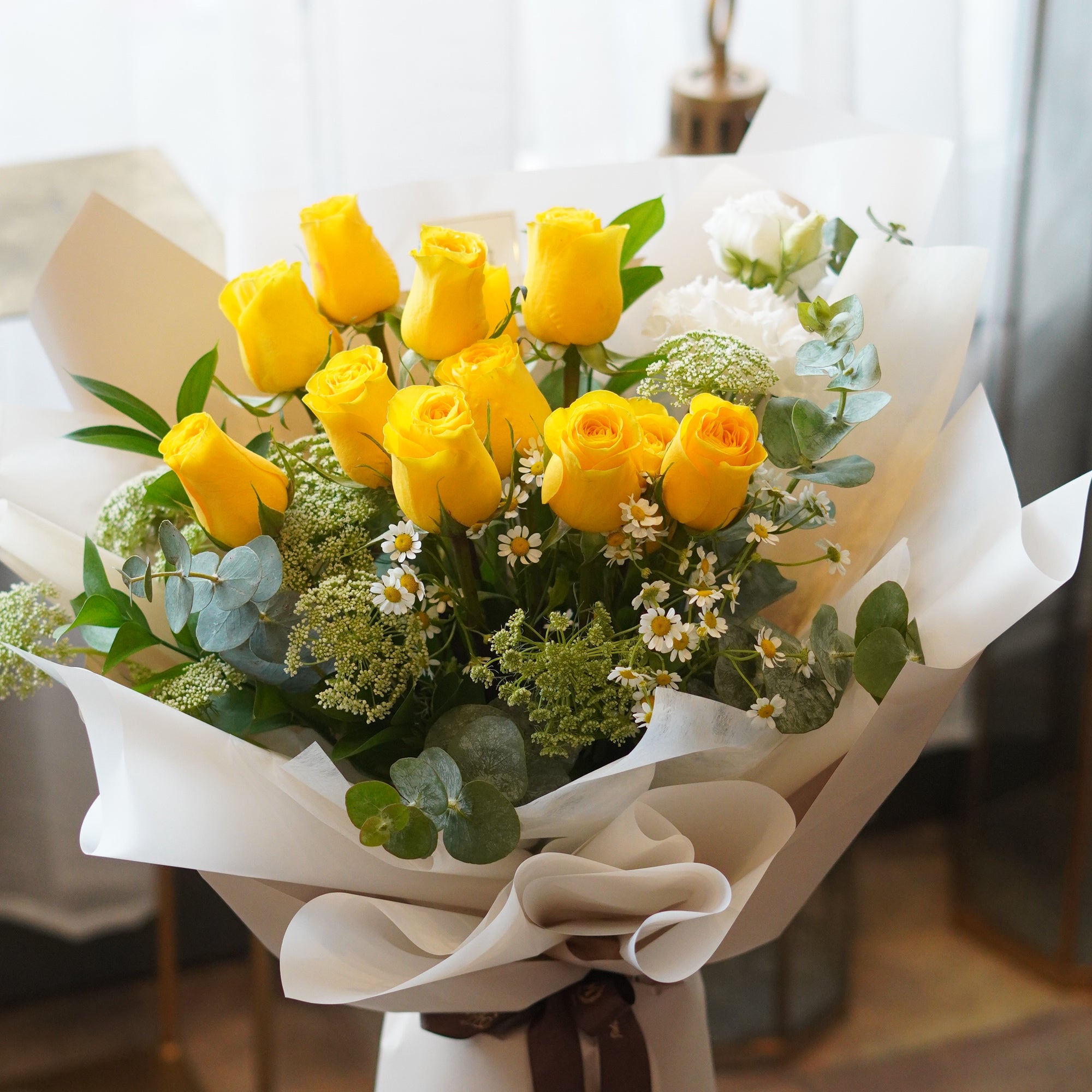 Yellow rose bouquet with white daisies and eucalyptus wrapped in white paper – same day flower delivery Toronto
