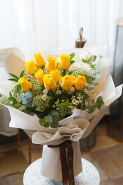 Yellow rose bouquet with white daisies and eucalyptus wrapped in white paper – same day flower delivery Toronto
