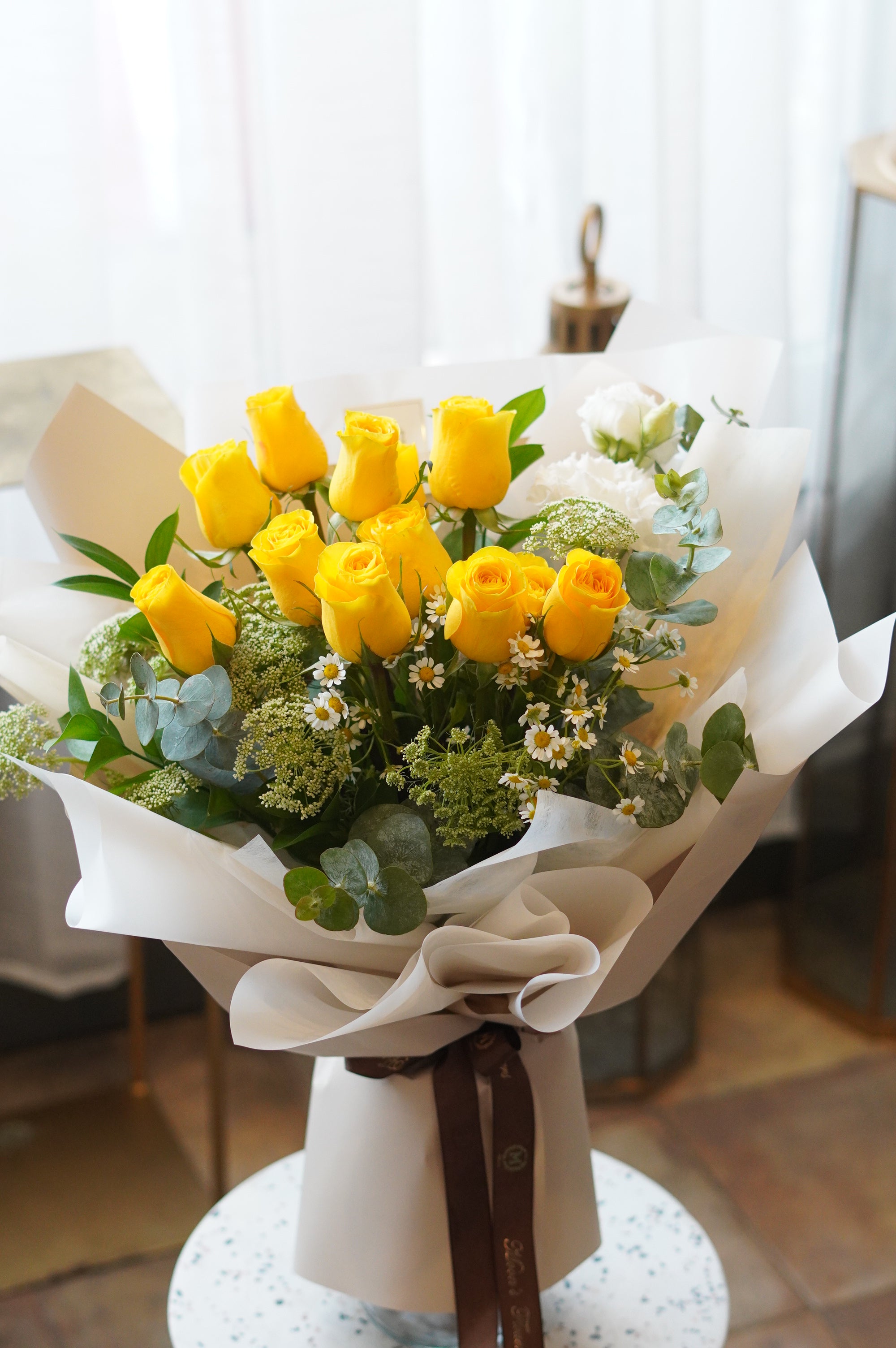 Yellow rose bouquet with white daisies and eucalyptus wrapped in white paper – same day flower delivery Toronto

