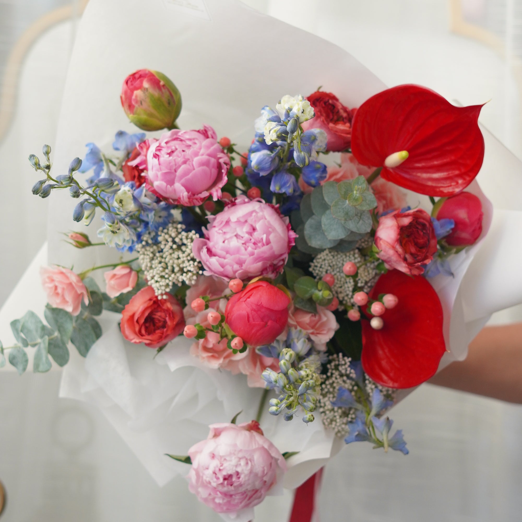 Blushing Symphony floral bouquet featuring premium pink peony, red anthurium, and delicate lisianthus in a glass vase. Same-day flower delivery in Toronto, Oakville, and the GTA