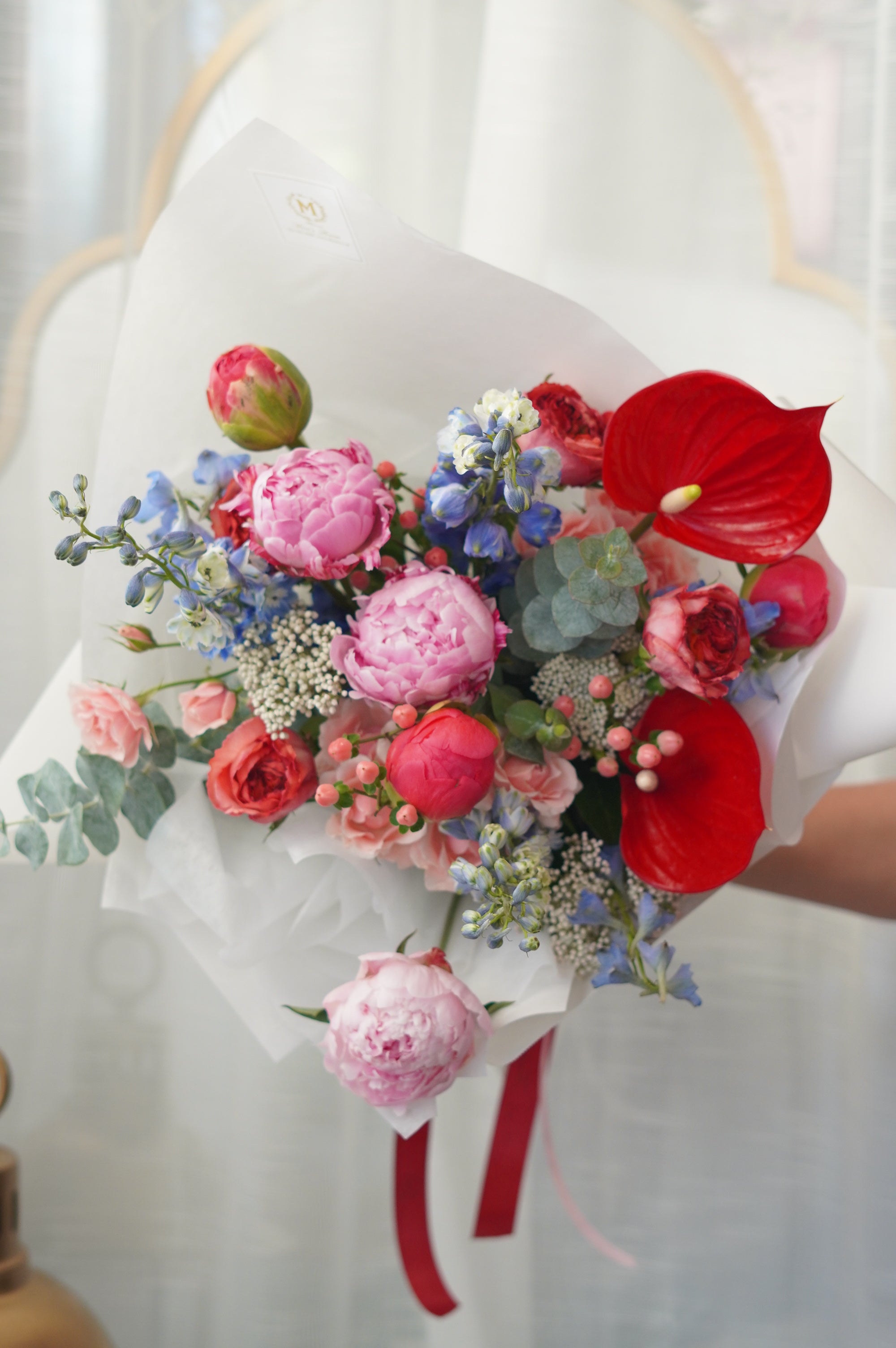 Blushing Symphony floral bouquet featuring premium pink peony, red anthurium, and delicate lisianthus in a glass vase. Same-day flower delivery in Toronto, Oakville, and the GTA
