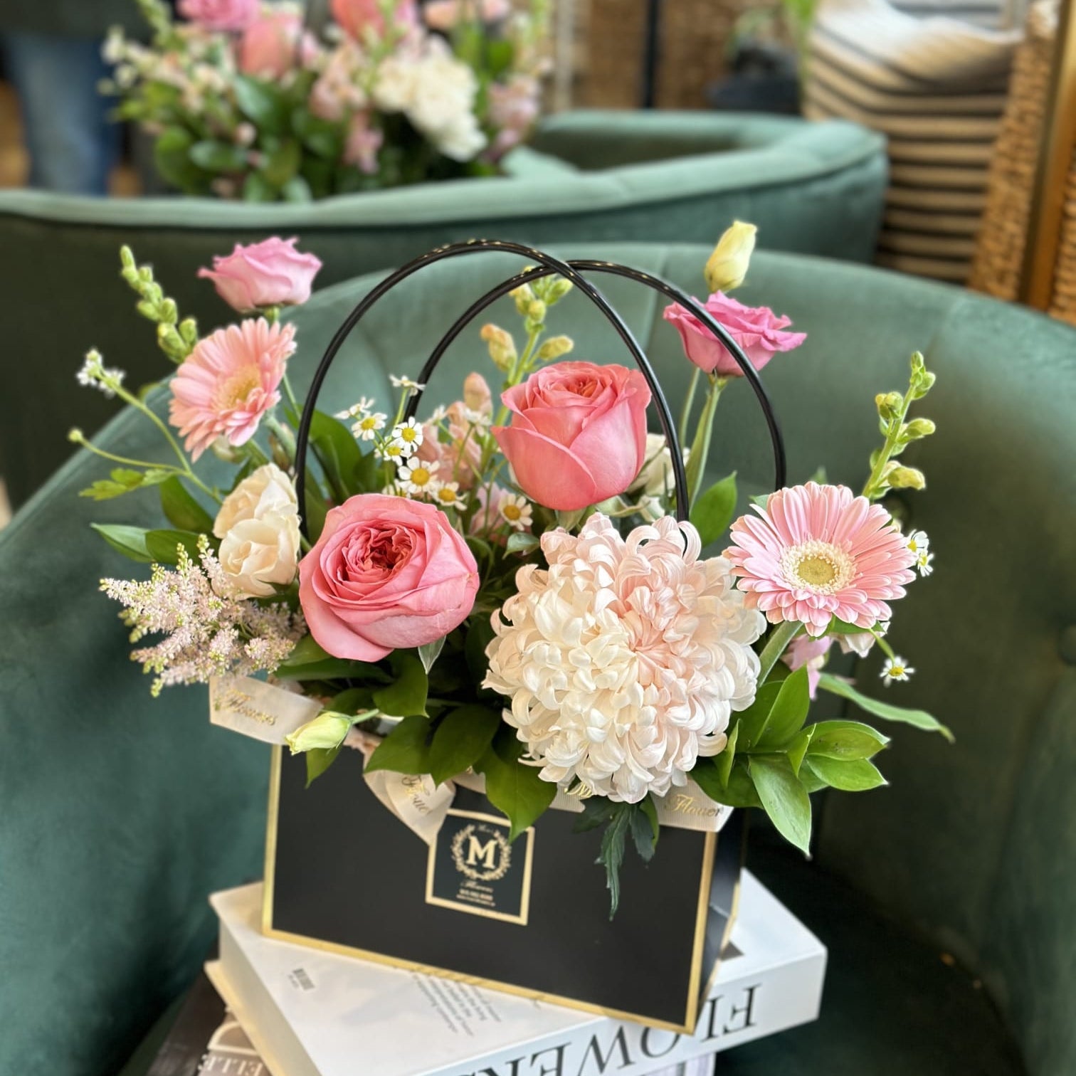 Chic ready to gift floral bag arrangement by Moons Flowers with pink garden Roses, chrysanthemum, and gerbera daisy. Convenient same-day delivery available in Oakville