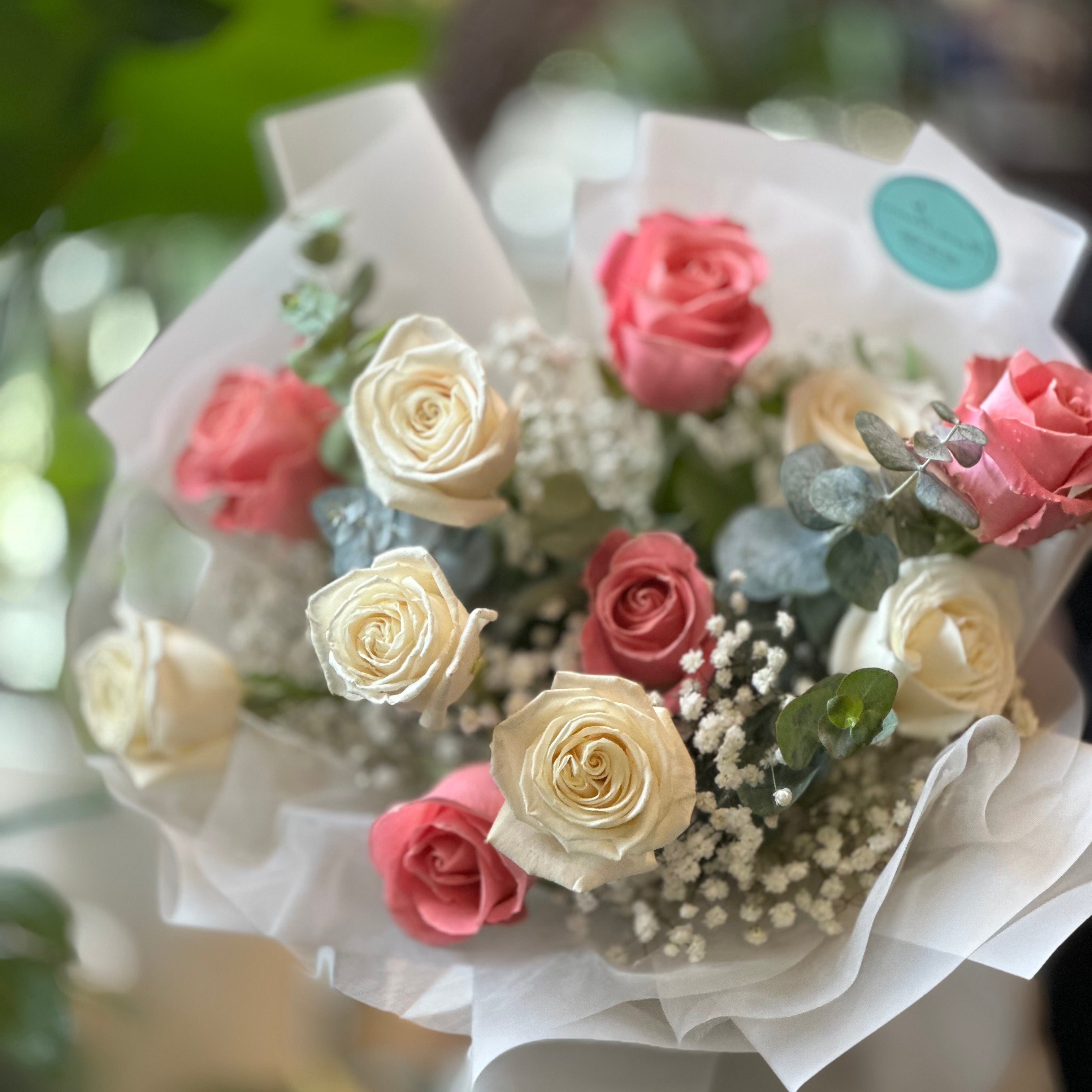 Close-up of pink and white roses arranged in a classic bouquet style