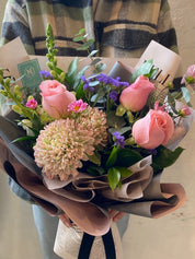 Close-up detail of fresh pink and violet floral arrangement by Moon's Flowers Toronto florist.