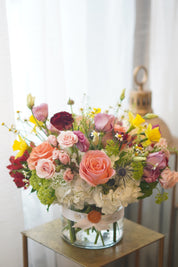Close-up of Beauty and the Beast style floral arrangement with peach roses and hydrangea