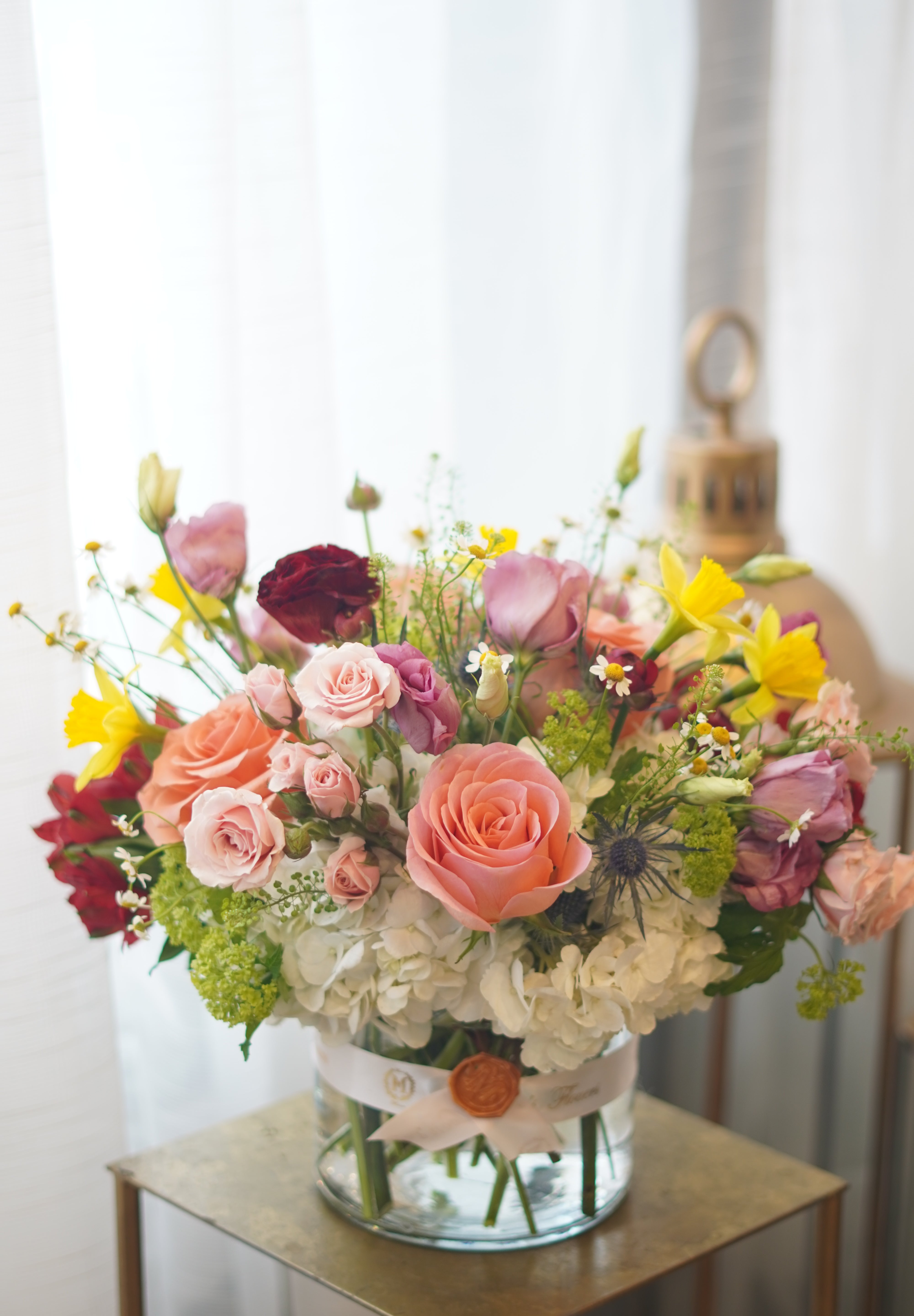 Close-up of Beauty and the Beast style floral arrangement with peach roses and hydrangea