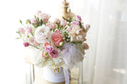 Close-up of blush roses, ranunculus and tulips in pastel flower box arrangement