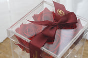 A close up image of the Red Preserved Roses in Acrylic Box that dhow cases the