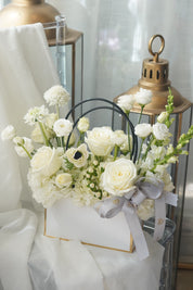 Vibrant pink and green floral basket featuring Gerber daisies and green hydrangeas in a modern white gift box with gold accents.