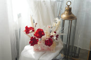 Preserved red rose arrangement with dried white florals in a transparent box featuring "Love You Mom" calligraphy.