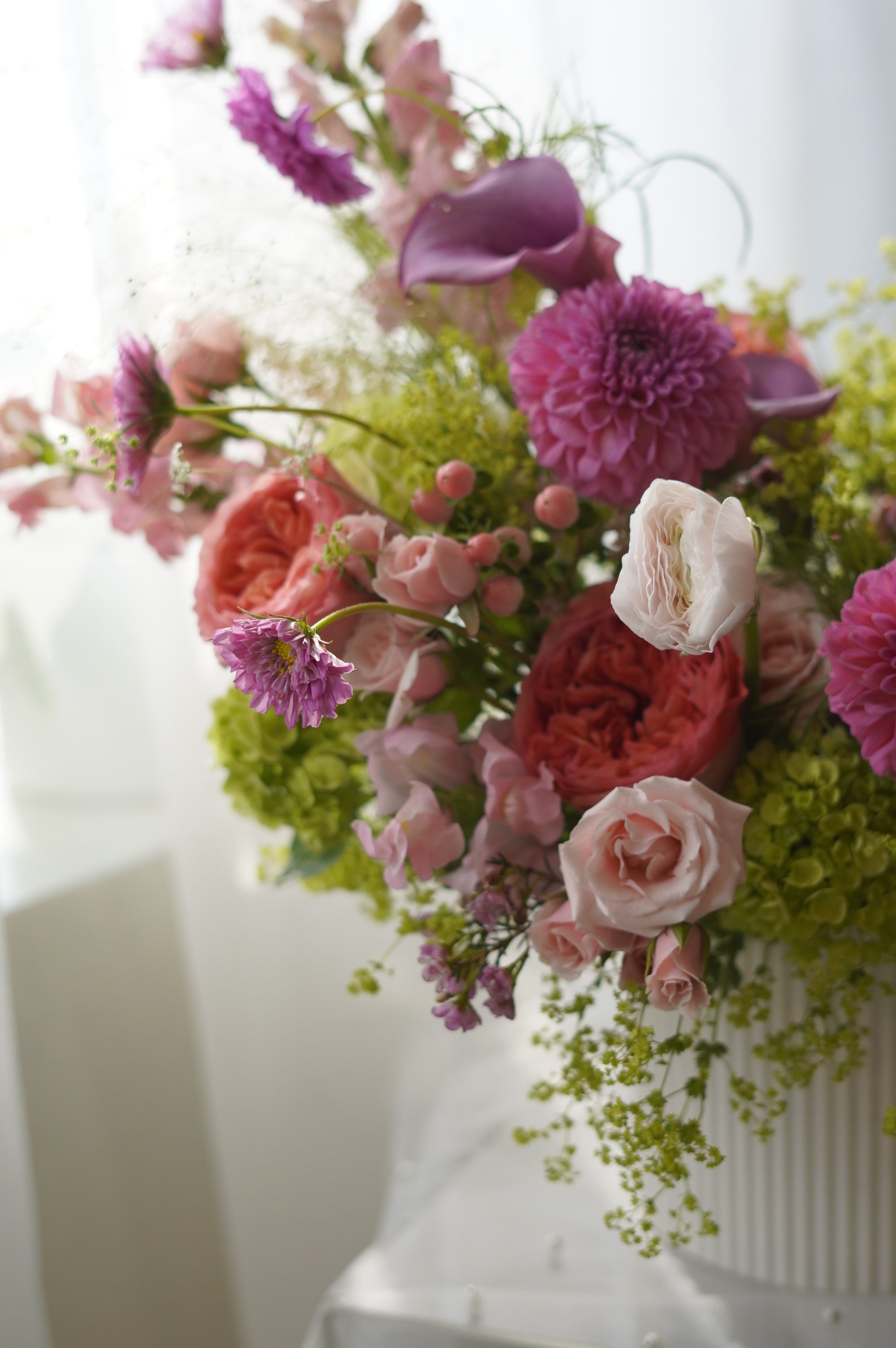 Pink dahlias and coral garden roses in lush garden-style arrangement — Toronto florist Moon's Flowers
