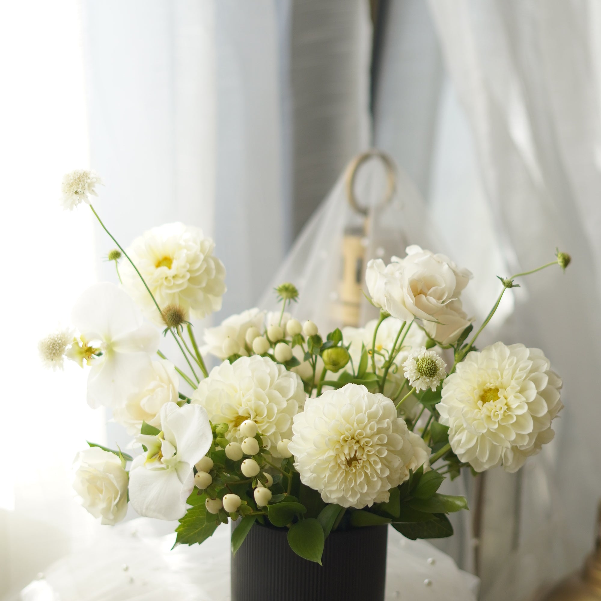 Ivory Dahlia Garden Arrangement in black ribbed vase — same-day flower delivery Toronto