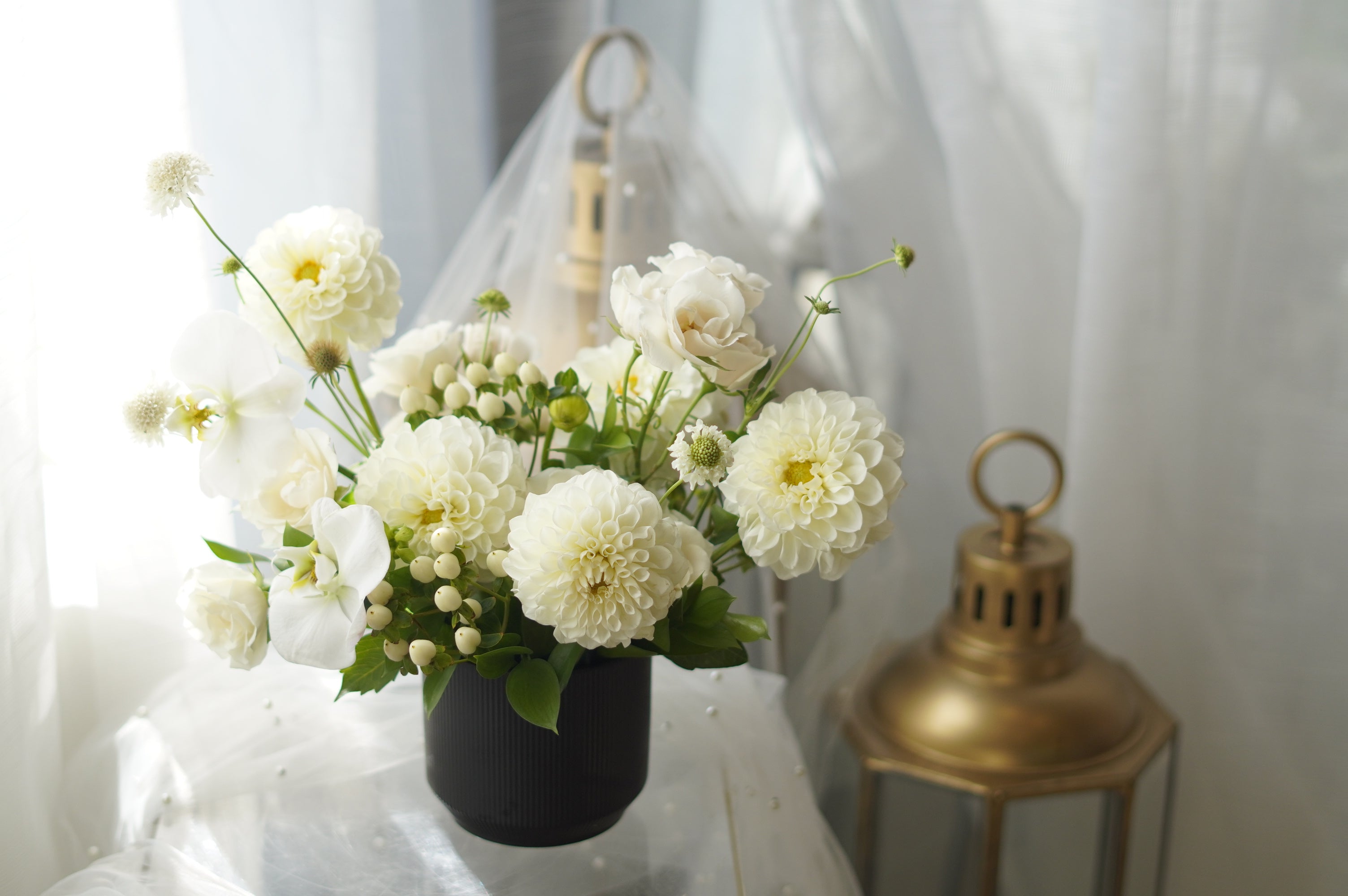 Ivory Dahlia Garden Arrangement in black ribbed vase — same-day flower delivery Toronto