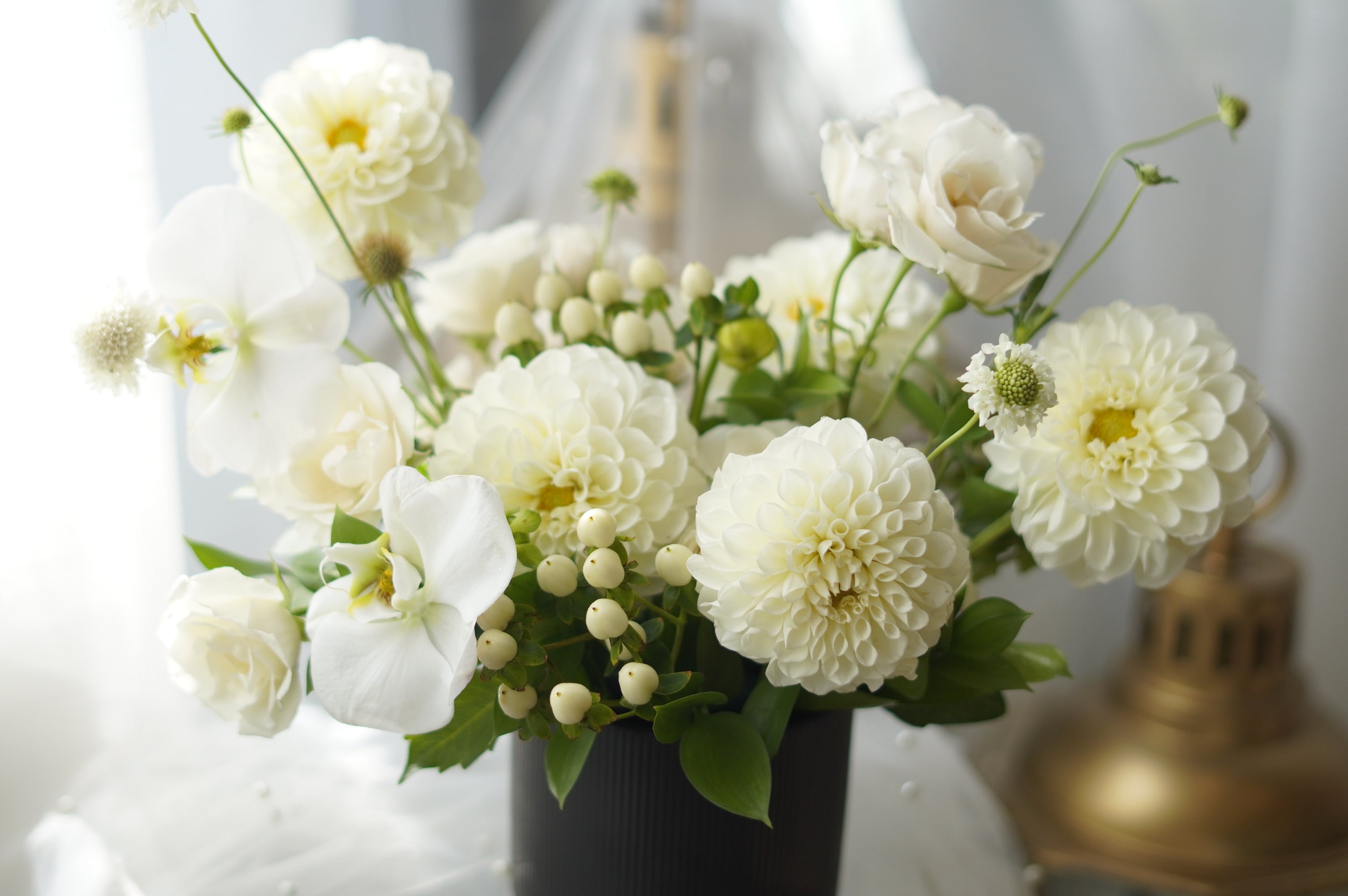 Ivory Dahlia Garden Arrangement in black ribbed vase — same-day flower delivery Toronto