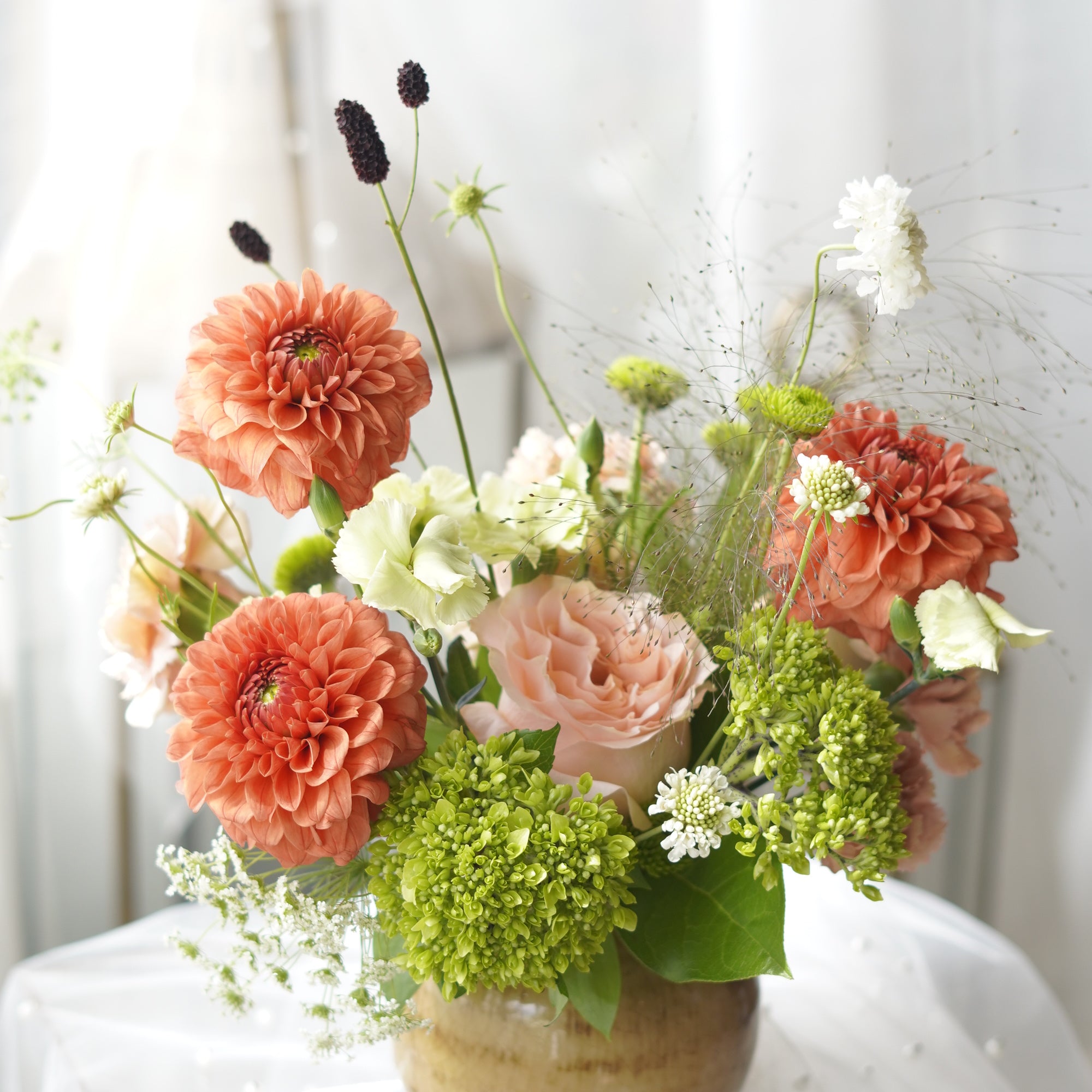 Lush orange dahlia floral arrangement with blush rose and green viburnum — GTA florist same-day delivery
