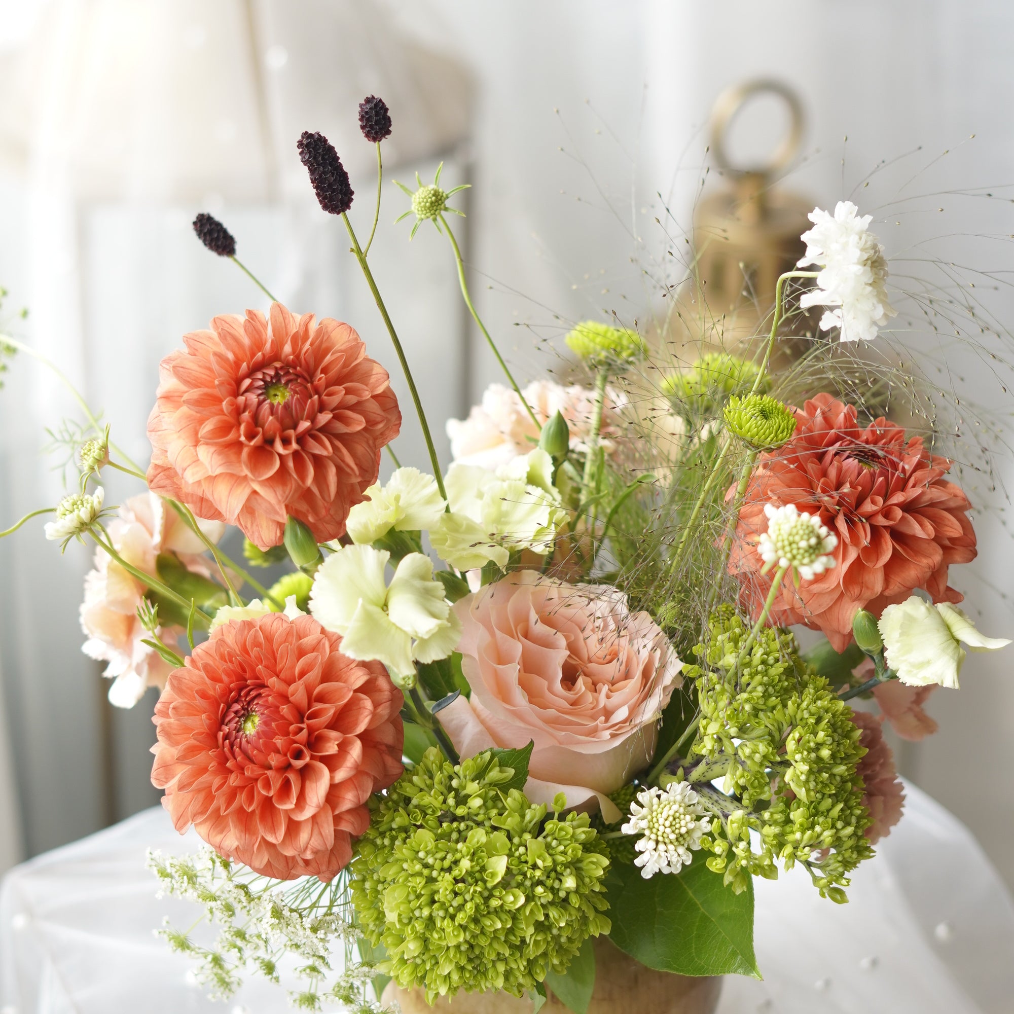 Coral Dusk dahlia and garden rose arrangement in rustic gold ceramic vase — Toronto flower delivery