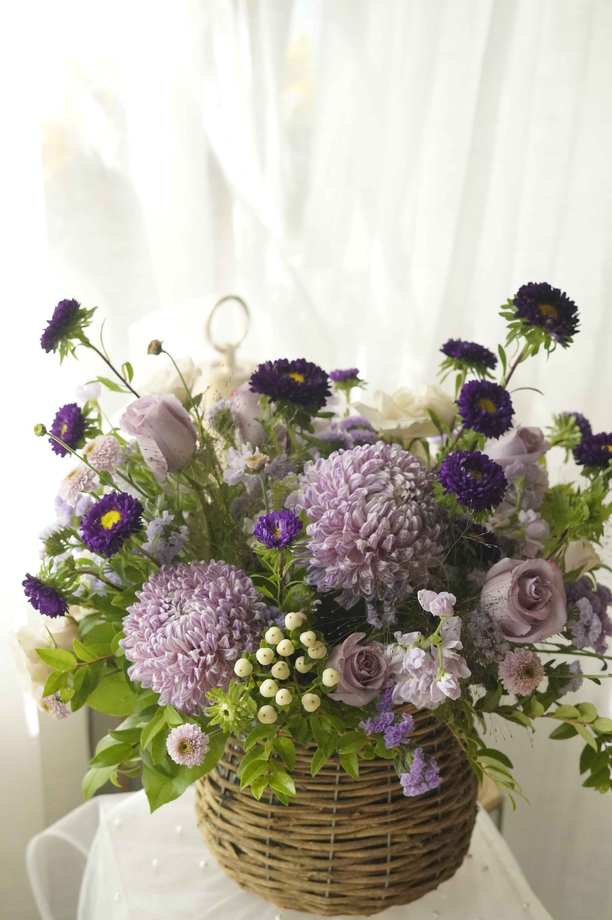 Lavender mums, purple asters and dusty roses with ivory snowberries — GTA florist arrangement