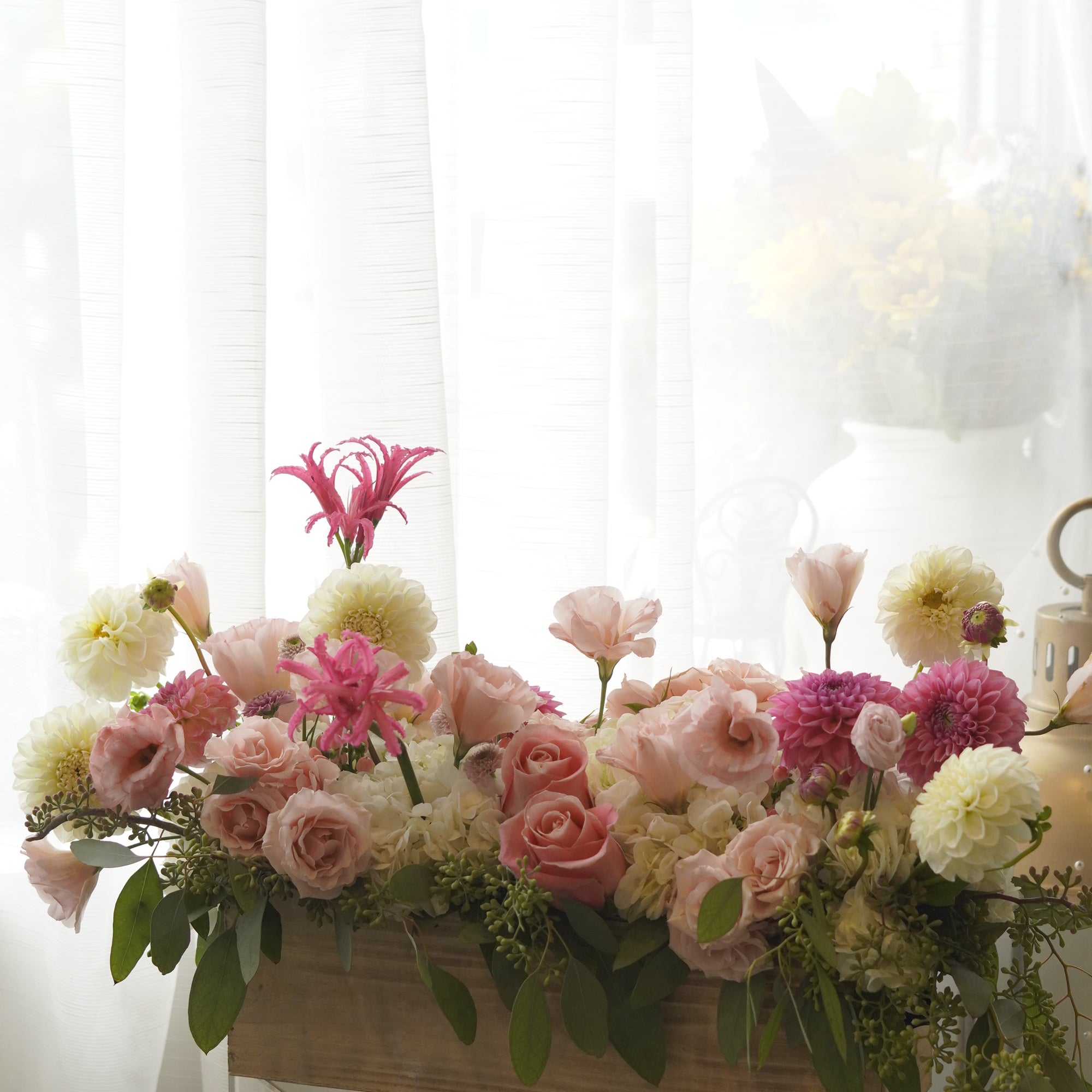 Pink roses, dahlias, hydrangea, and lisianthus garden arrangement