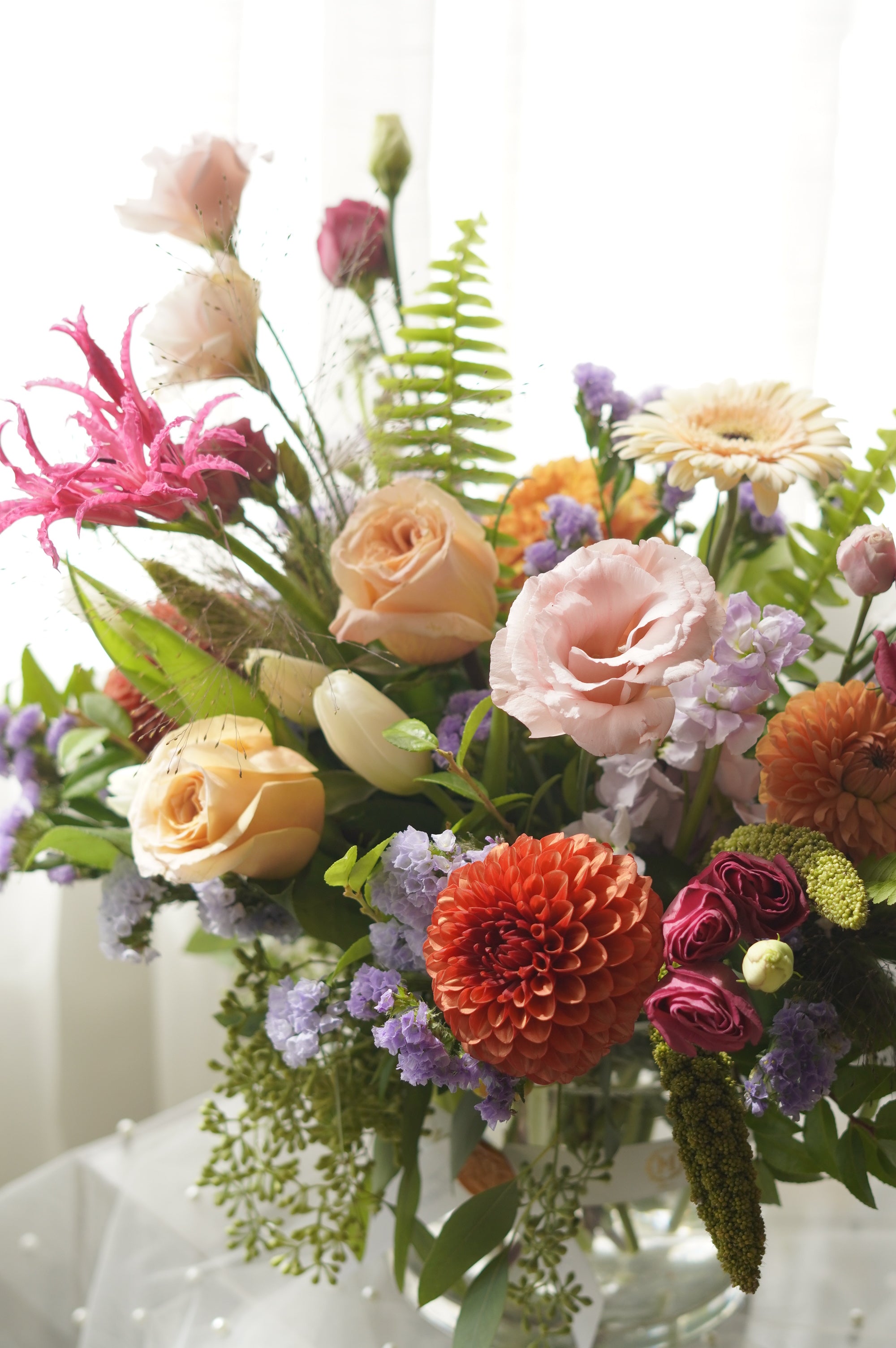 Tangerine floral arrangement with orange dahlias, peach roses and lavender blooms — Toronto flower delivery
