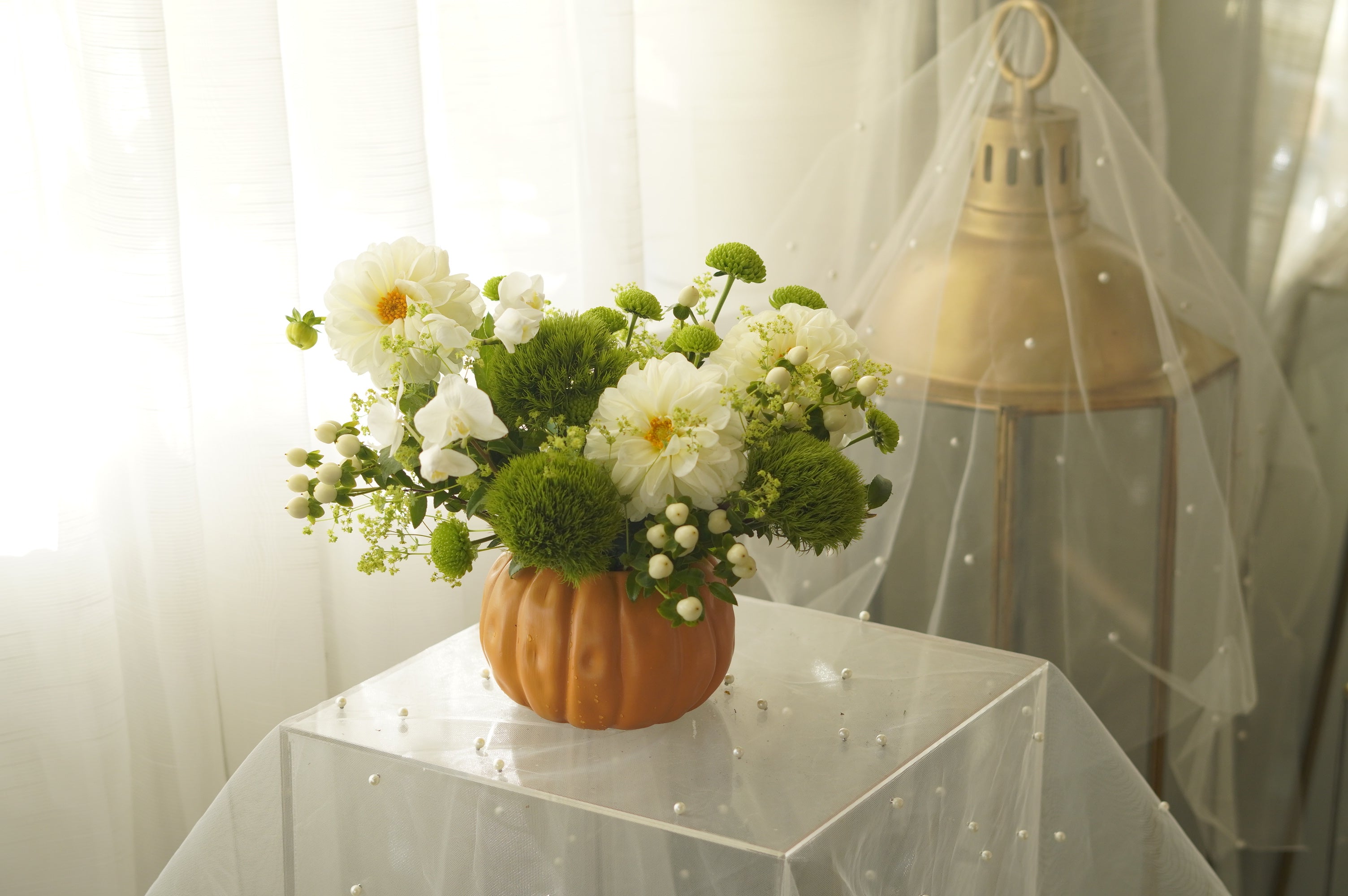 Close-up of carved pumpkin vase with fall floral details