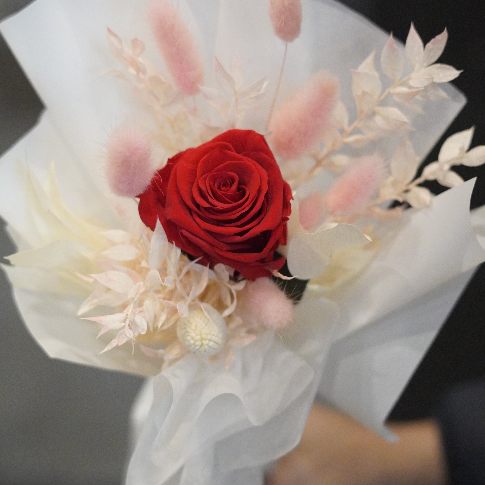 Close-up of single long stem preserved rose with dried flowers, white signature wrapping detail by Moon’s Flowers