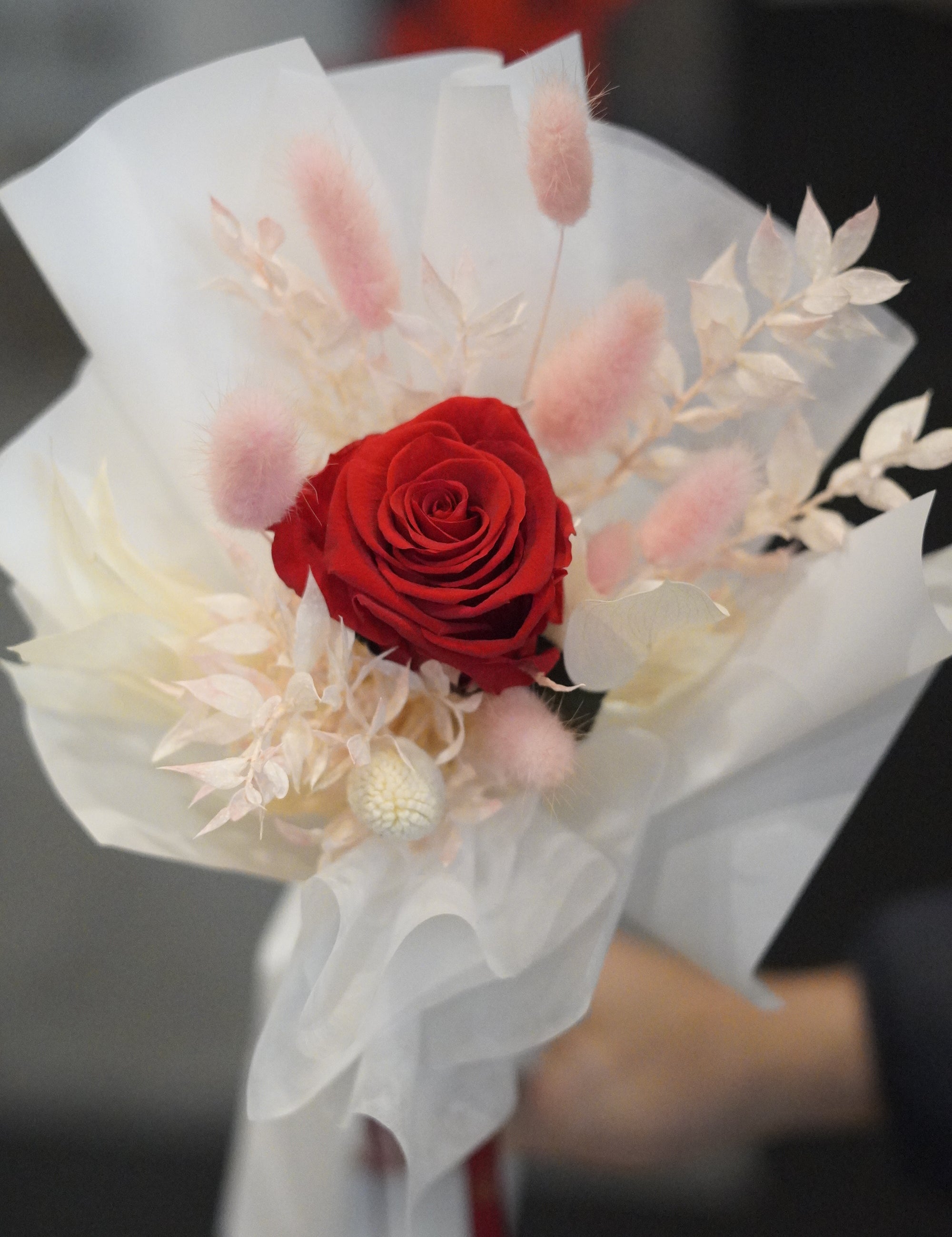 Close-up of single long stem preserved rose with dried flowers, white signature wrapping detail by Moon’s Flowers