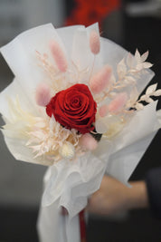 Close-up of single long stem preserved rose with dried flowers, white signature wrapping detail by Moon’s Flowers