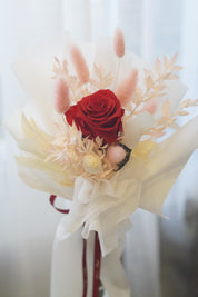 Single long stem preserved rose with dried flowers in elegant black signature wrapping by Moon’s Flowers