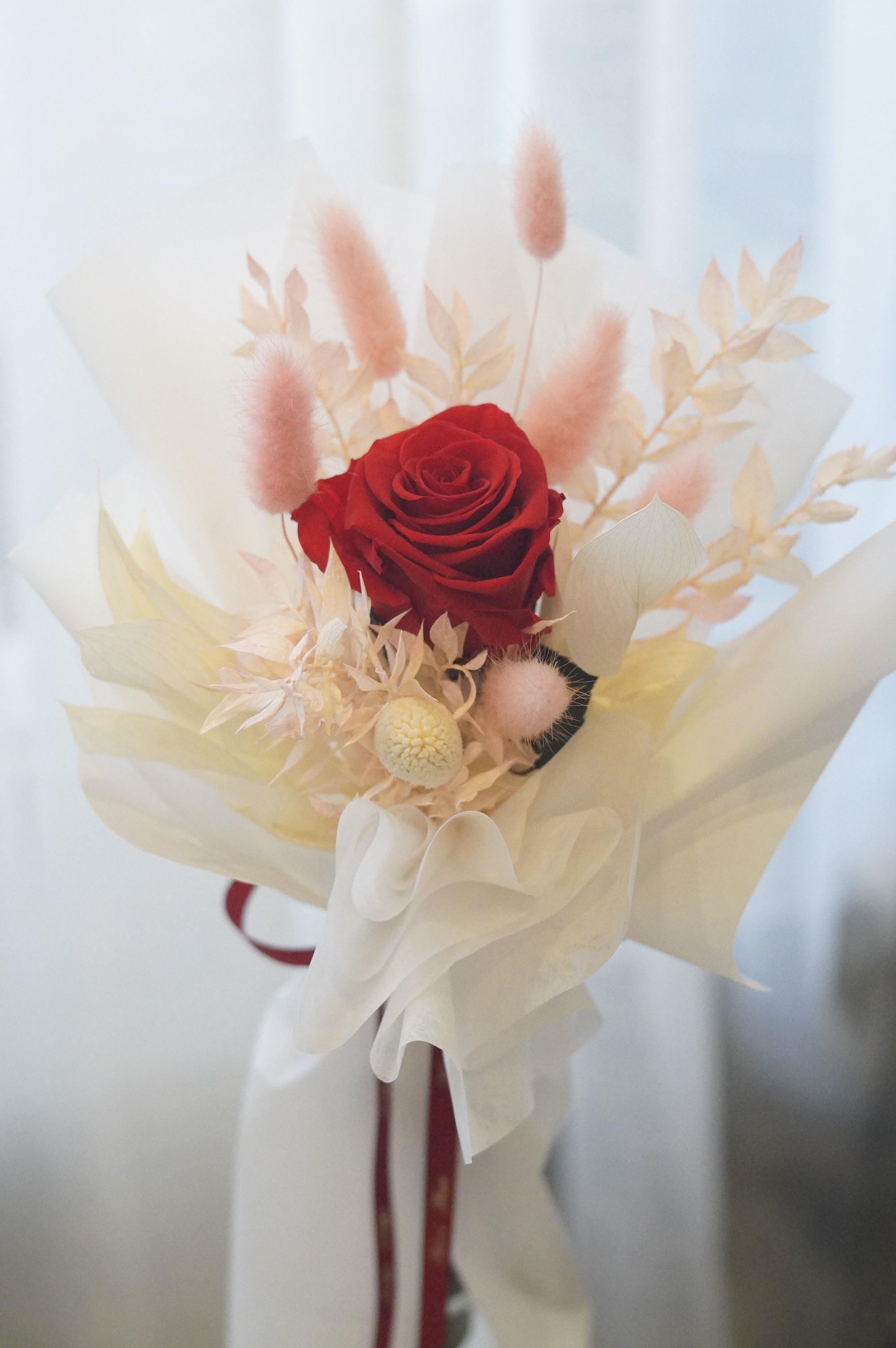 Single long stem preserved rose with dried flowers in elegant black signature wrapping by Moon’s Flowers