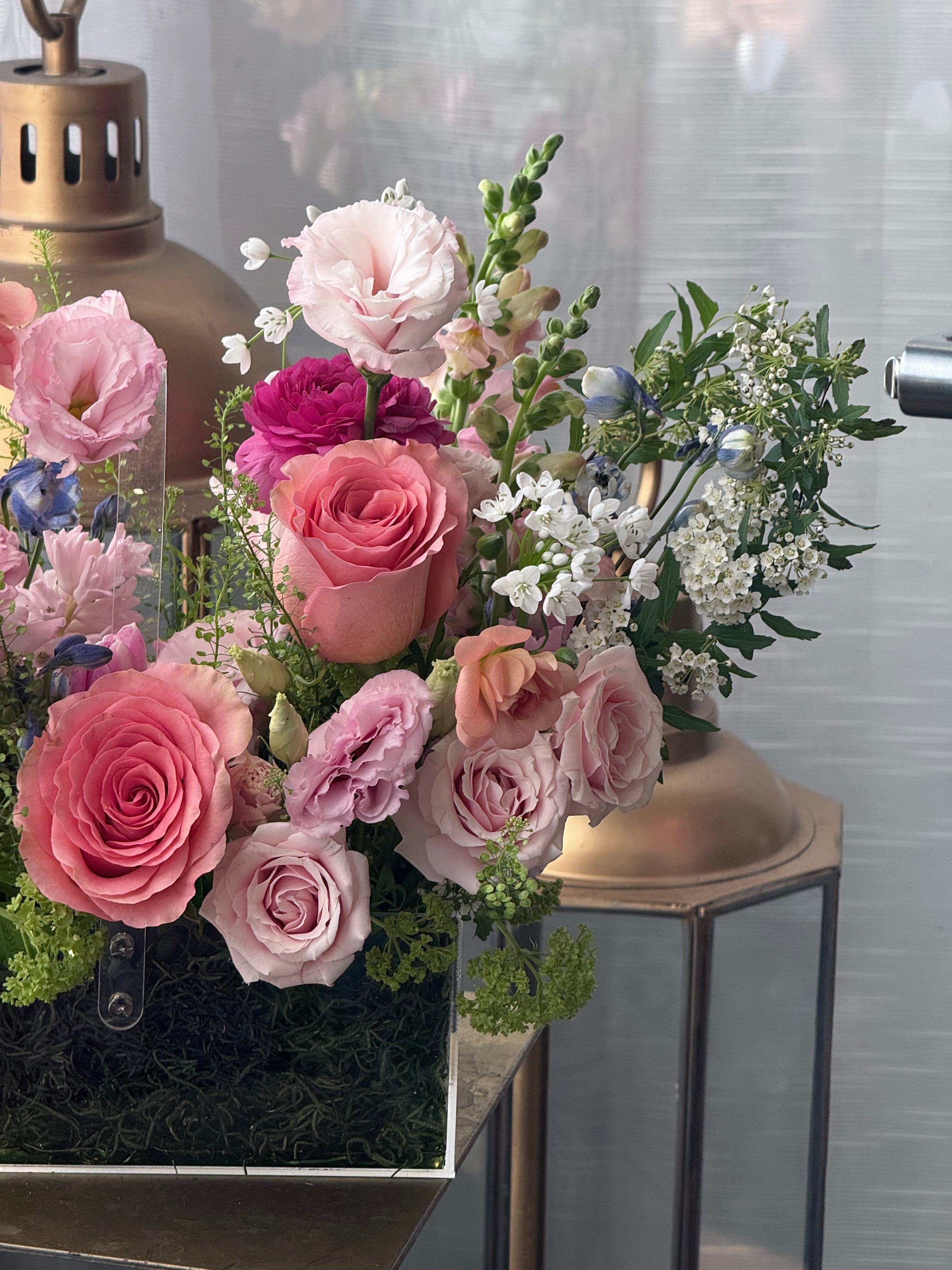 Bouquet of pink and white flowers on a metallic surface