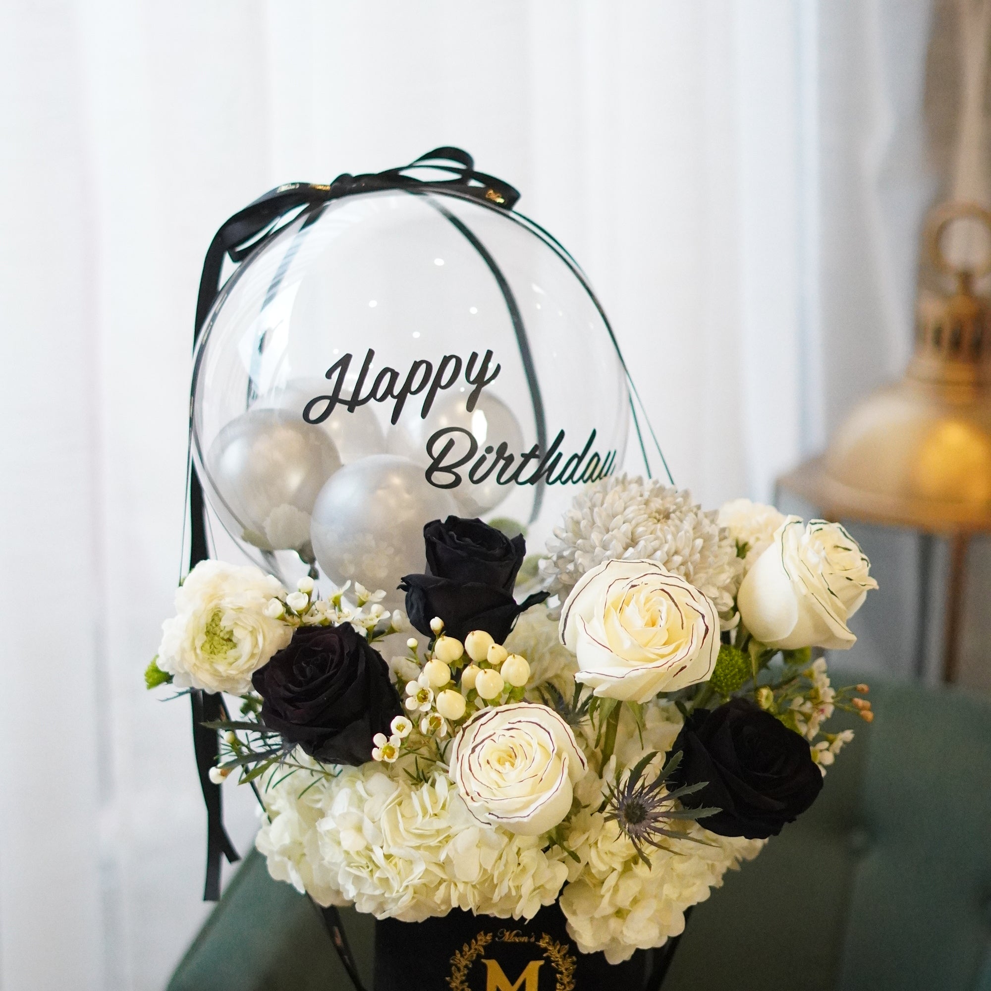 Black rose balloon bouquet with white roses arranged in a velvet flower box