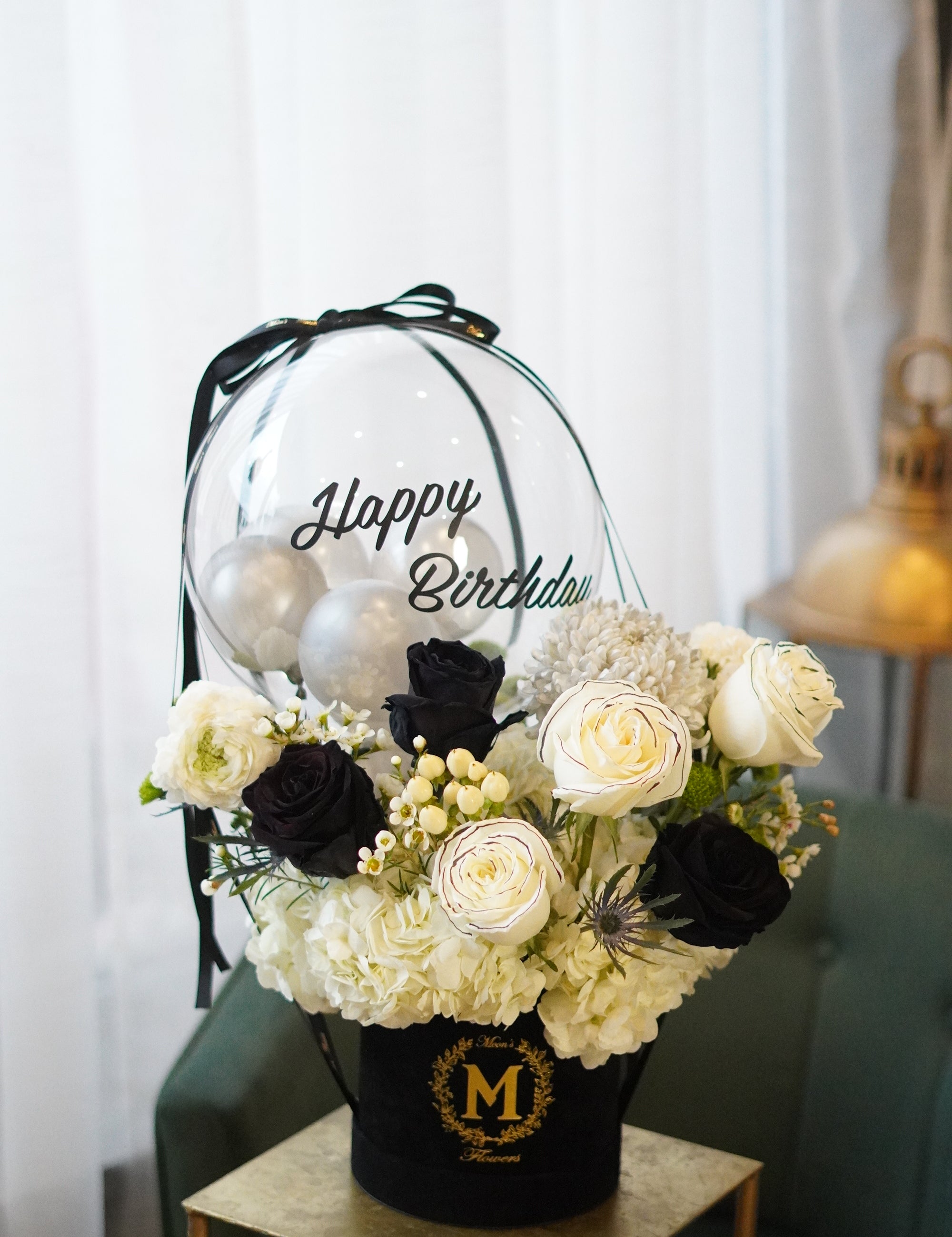 Black rose balloon bouquet with white roses arranged in a velvet flower box