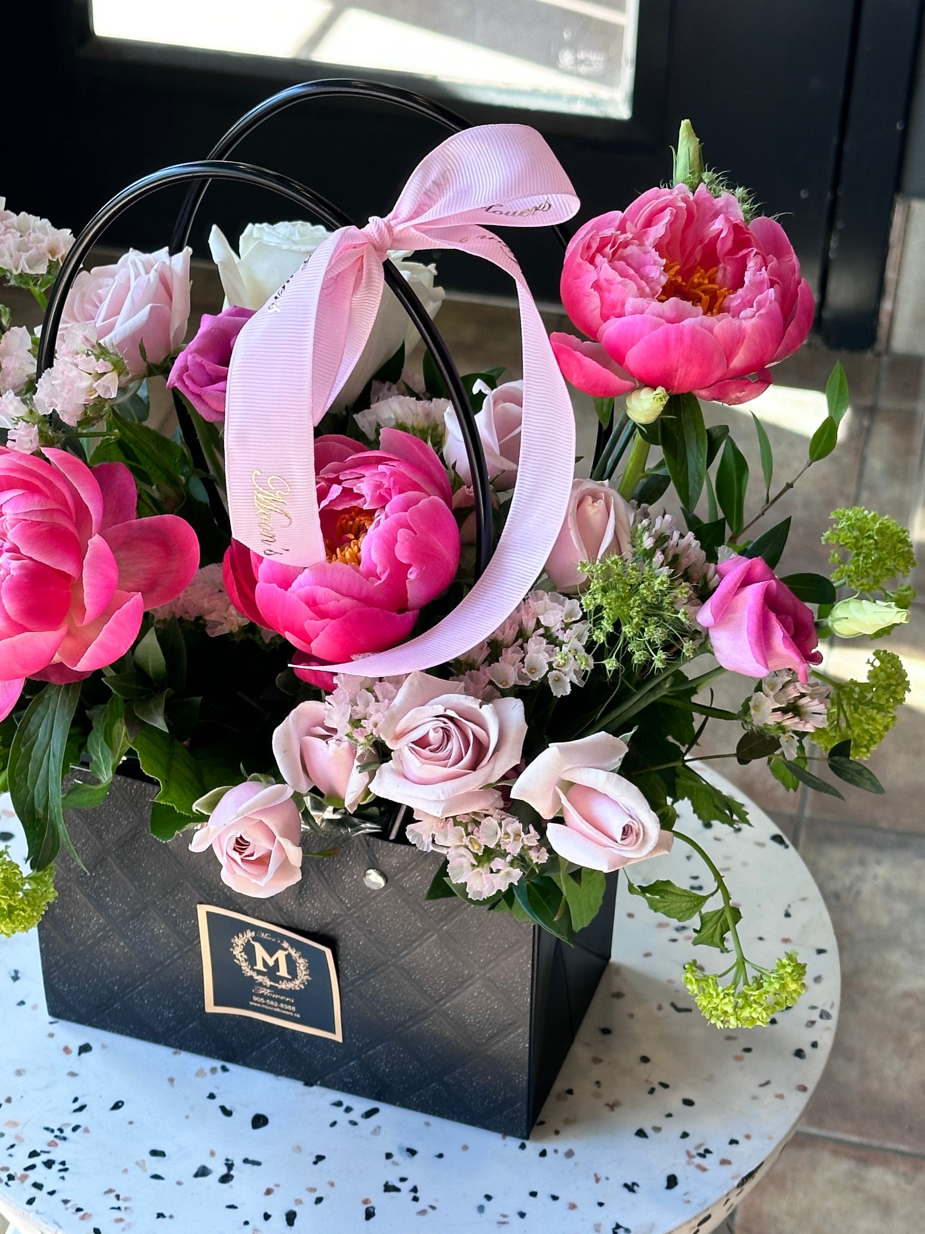 Toronto florist Moon's Flowers presents a premium Mother's Day peony basket. Elegant fresh cut flowers, including roses and seasonal blooms, professionally arranged in a gift basket with a decorative bow